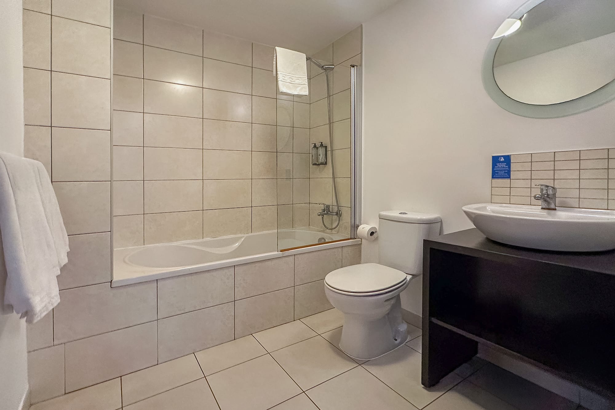 a bathroom with a tub and toilet