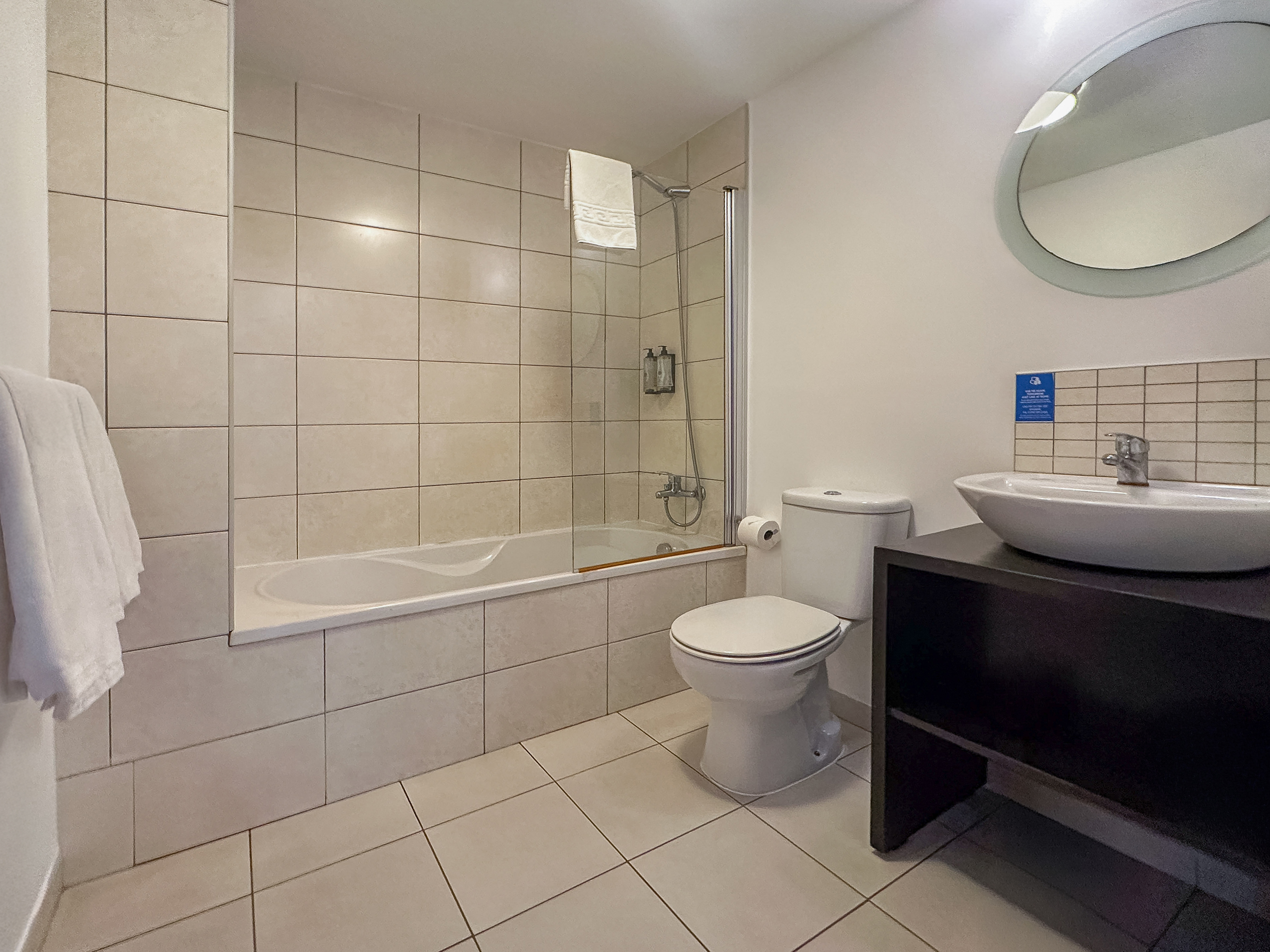 a bathroom with a tub and toilet