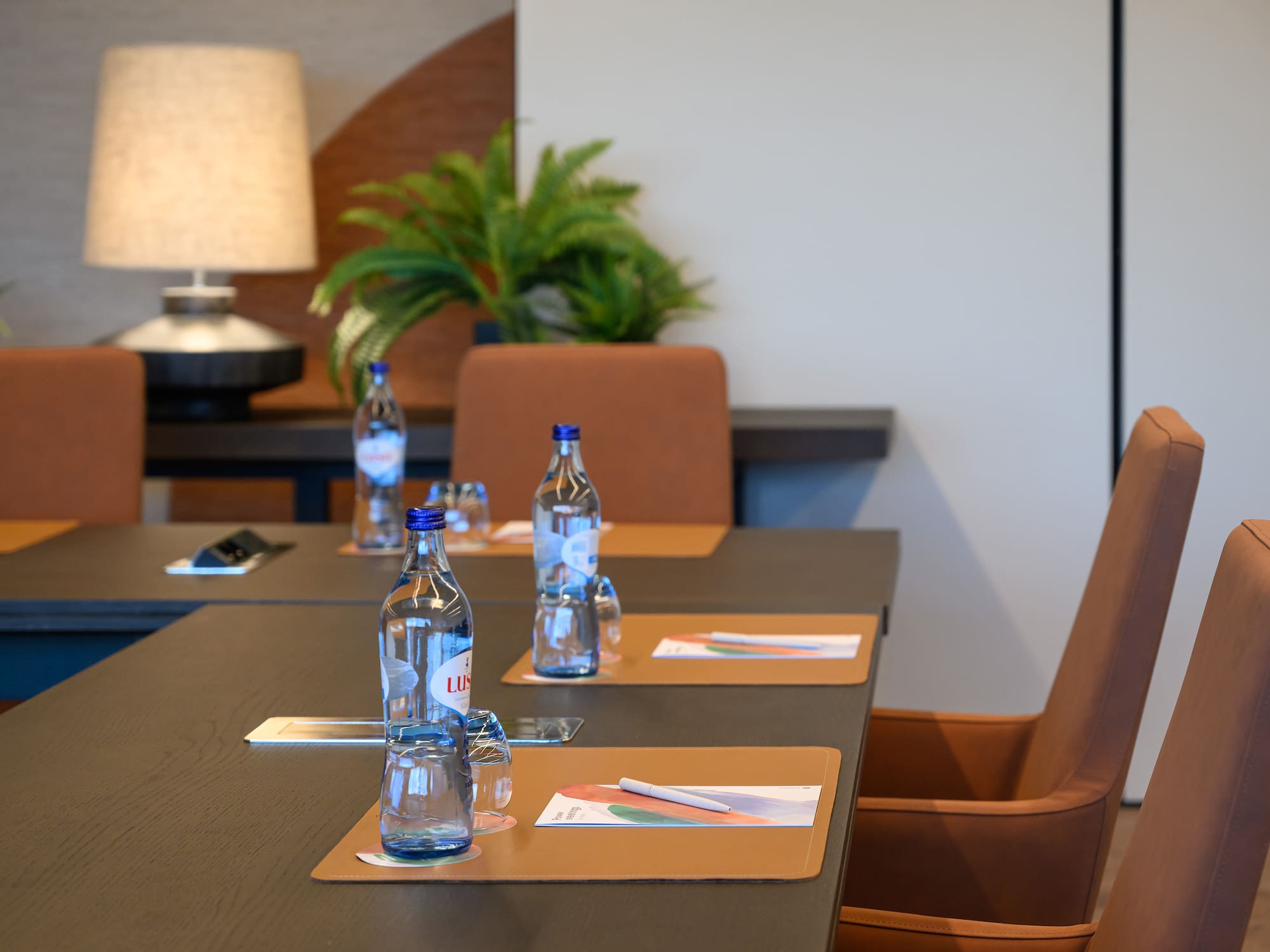 a table with water bottles and place mats
