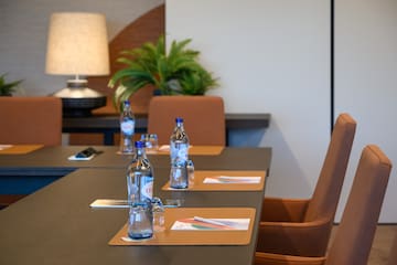 a table with water bottles and place mats