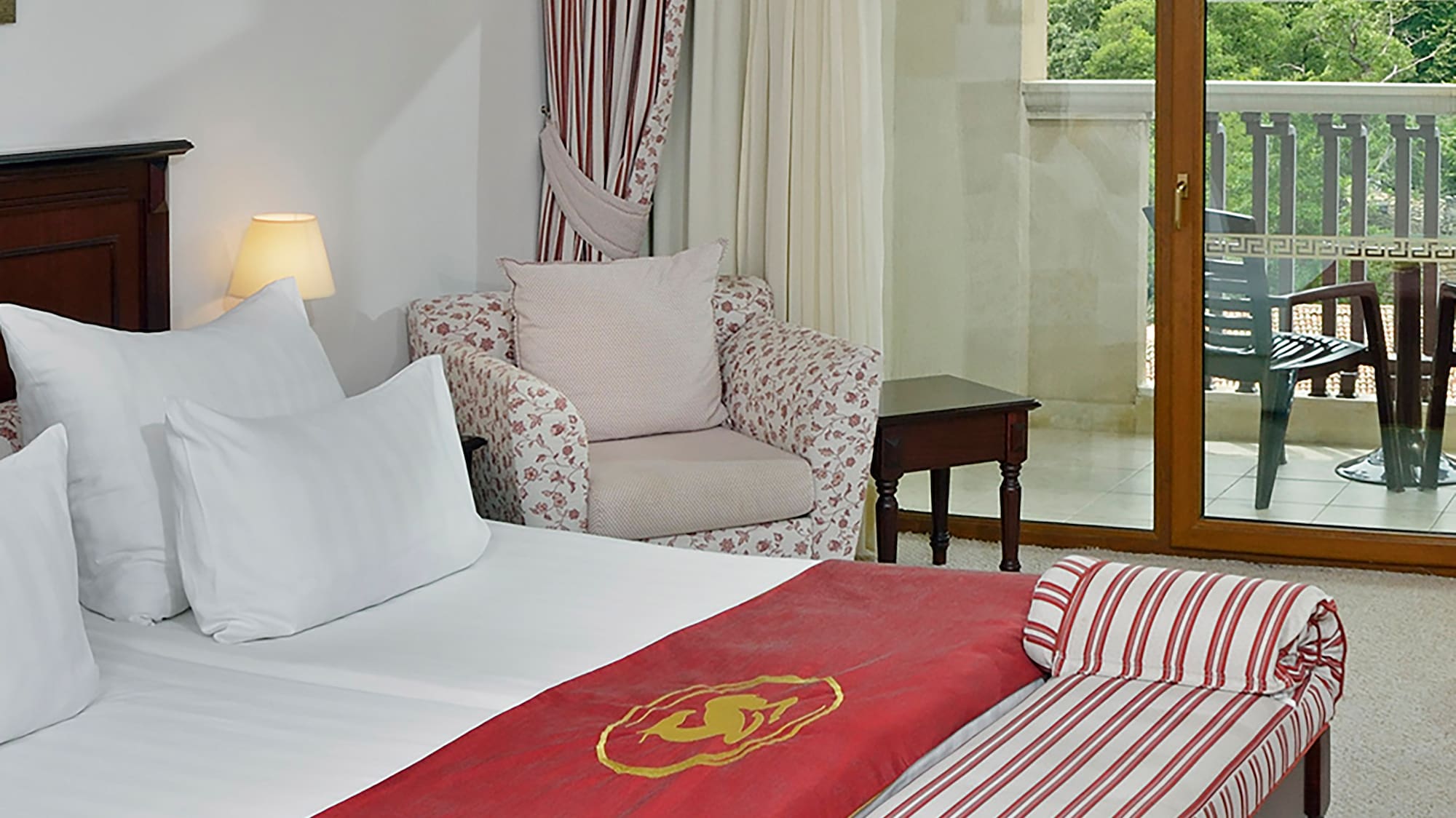 a hotel room with a bed and a chair