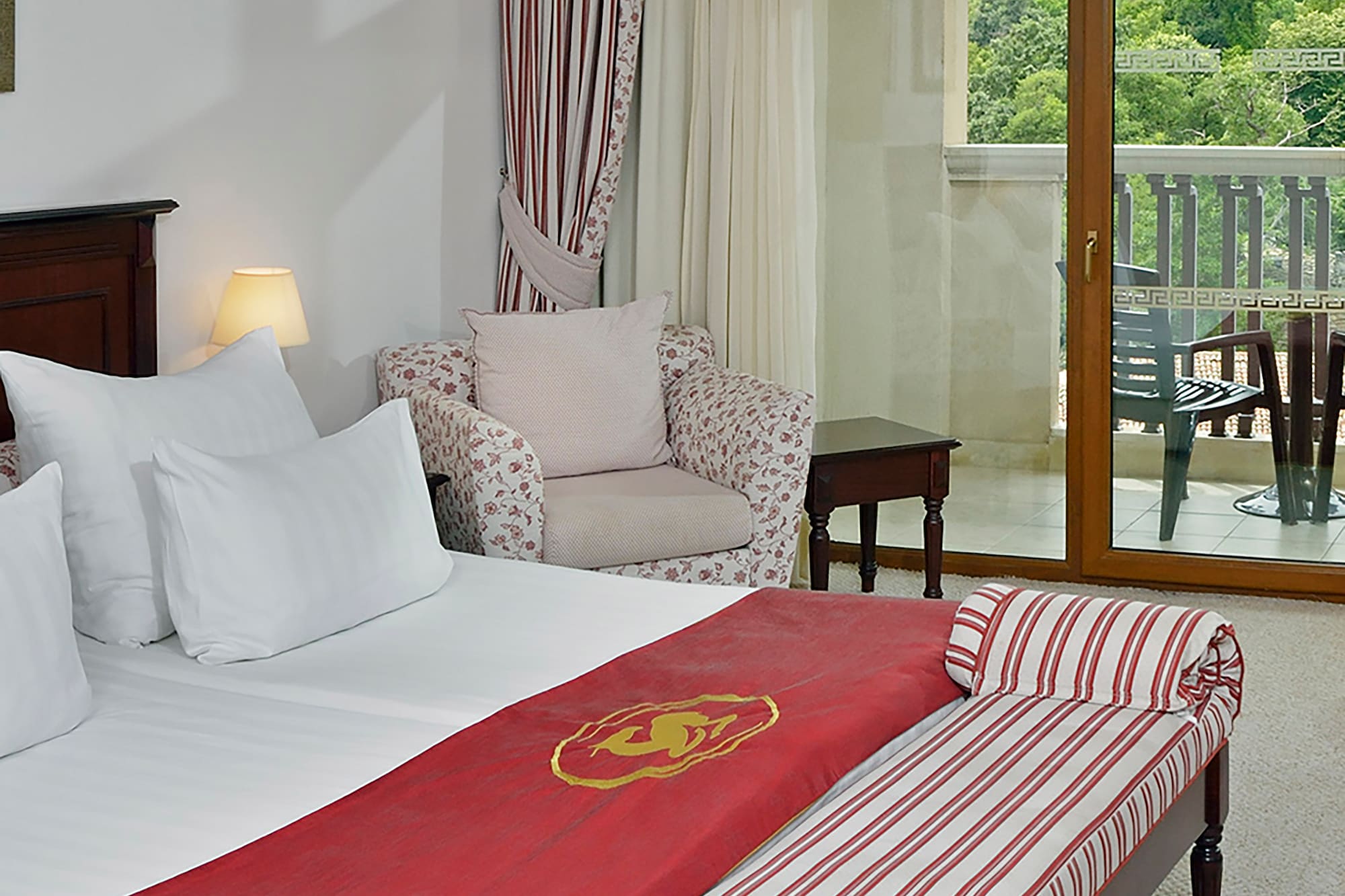 a hotel room with a bed and a chair