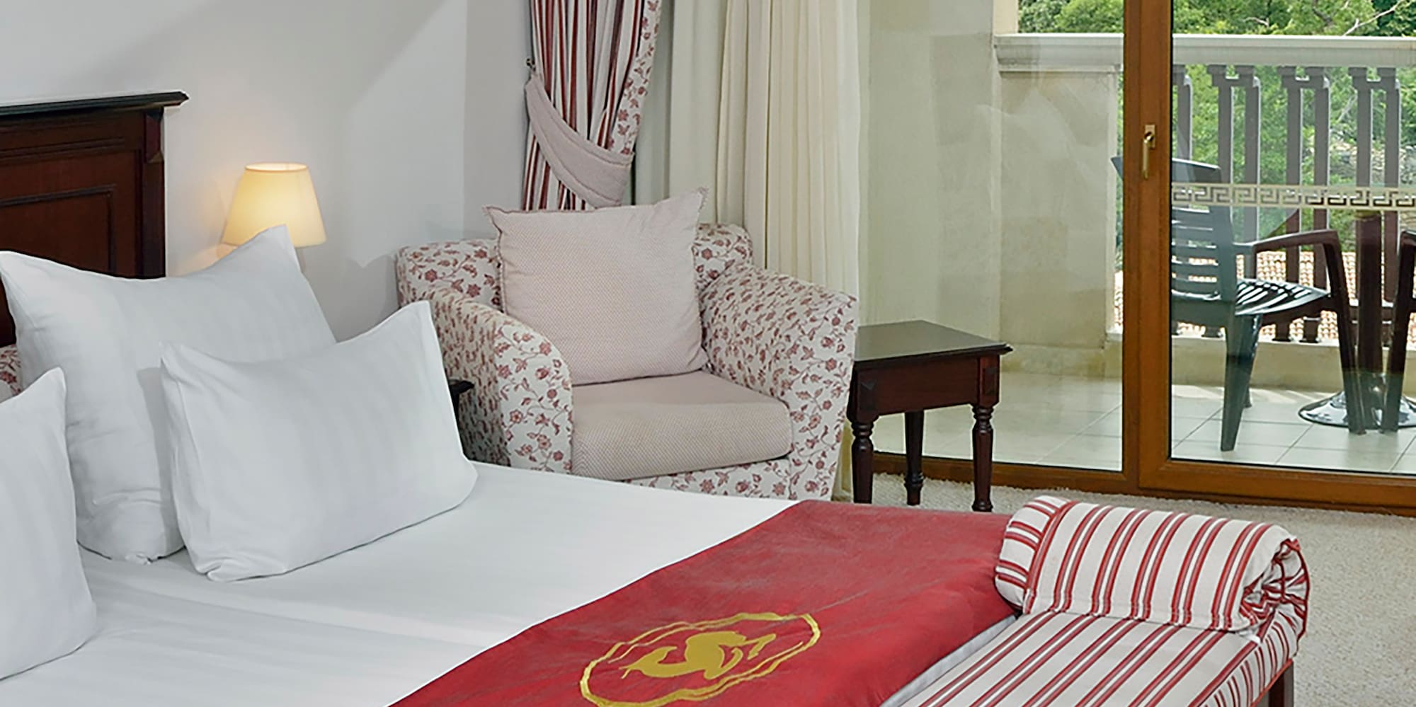 a hotel room with a bed and a chair