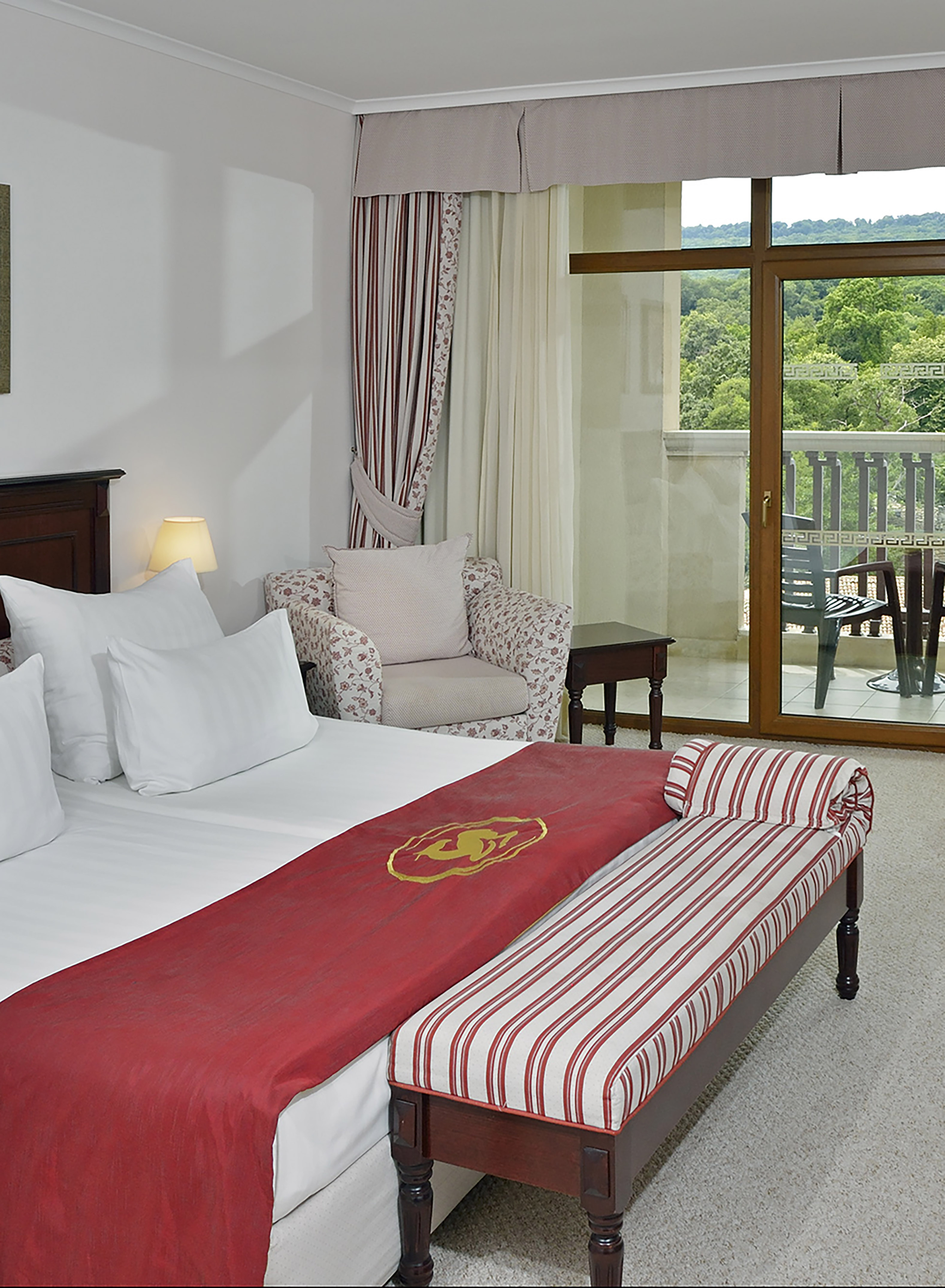 a hotel room with a bed and a chair