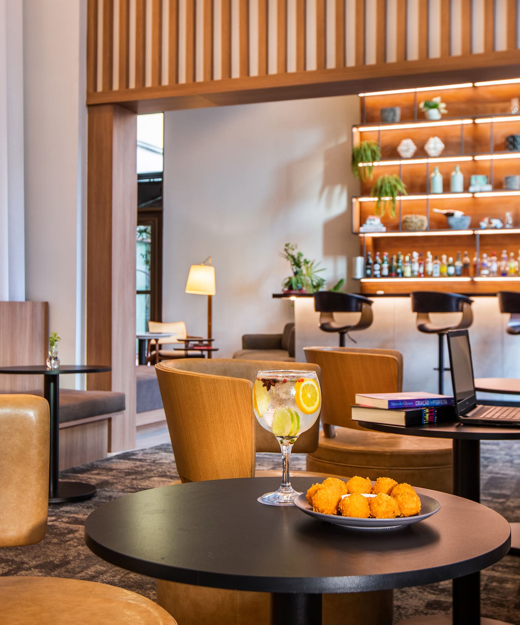 a room with a table and chairs and a laptop