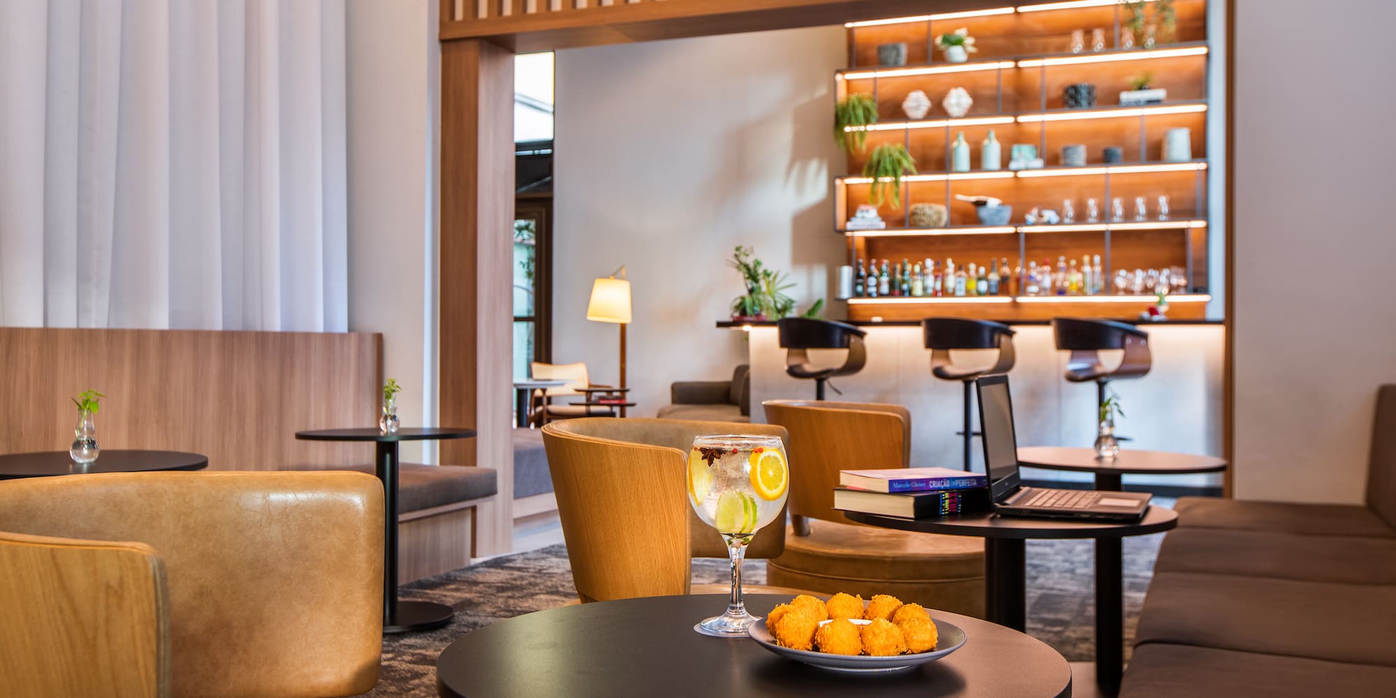 a room with a table and chairs and a laptop