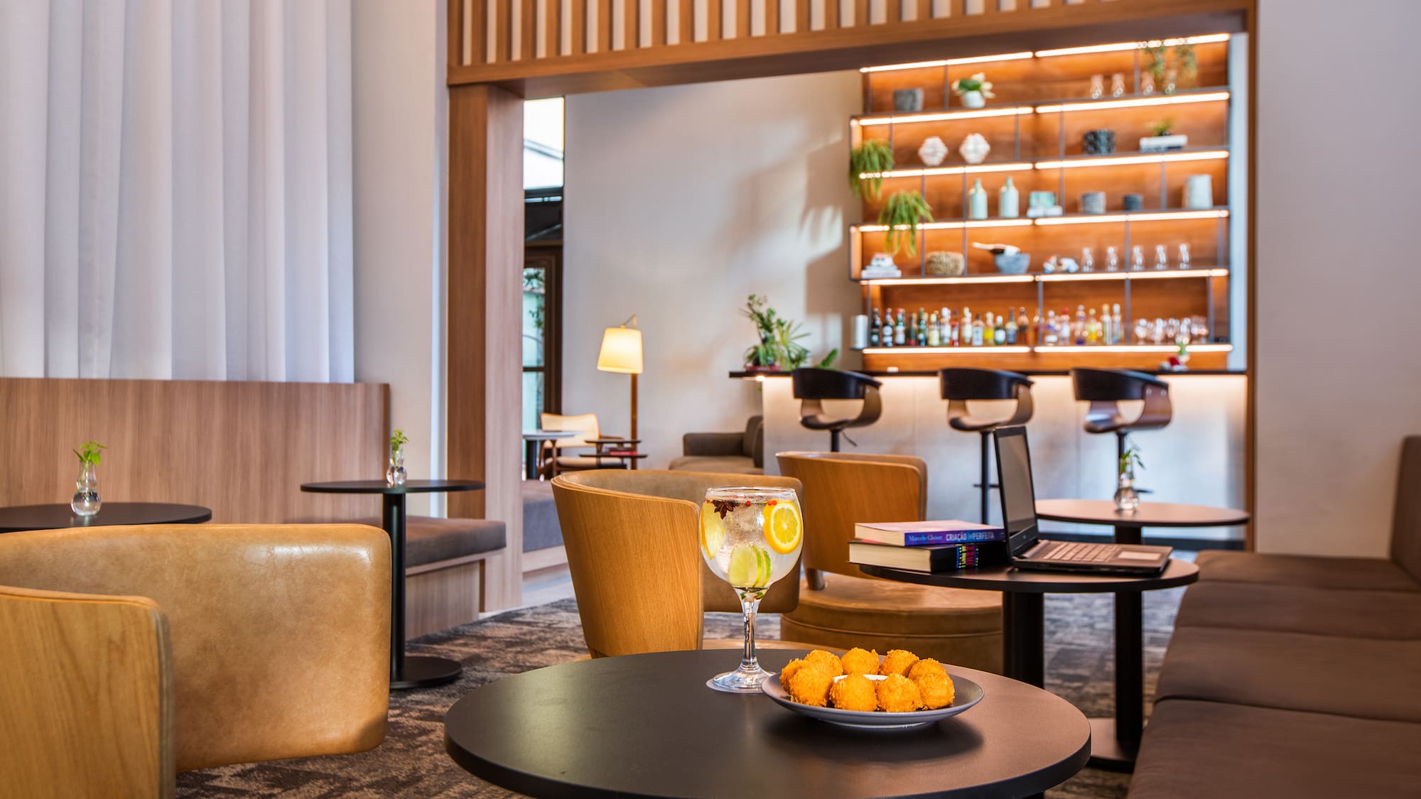 a room with a table and chairs and a laptop