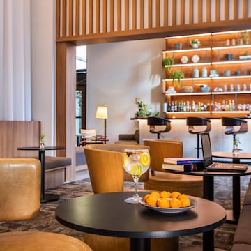 a room with a table and chairs and a laptop