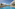 Tropical resort swimming pool, white hotel, palm trees, blue sky.