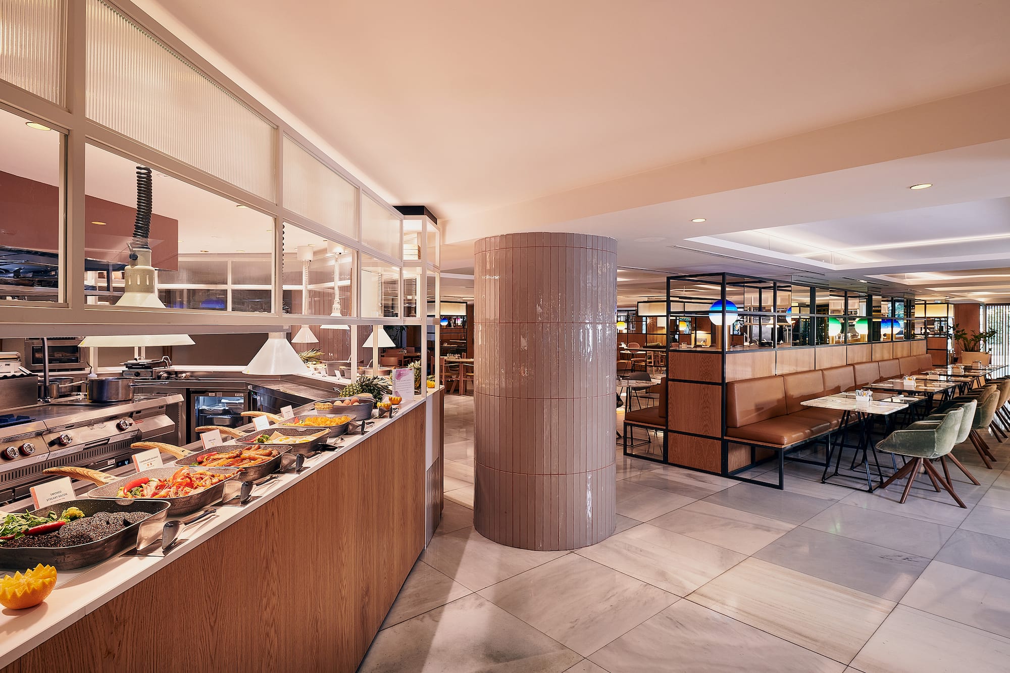 Hotel breakfast buffet with hot food counter and contemporary dining room.