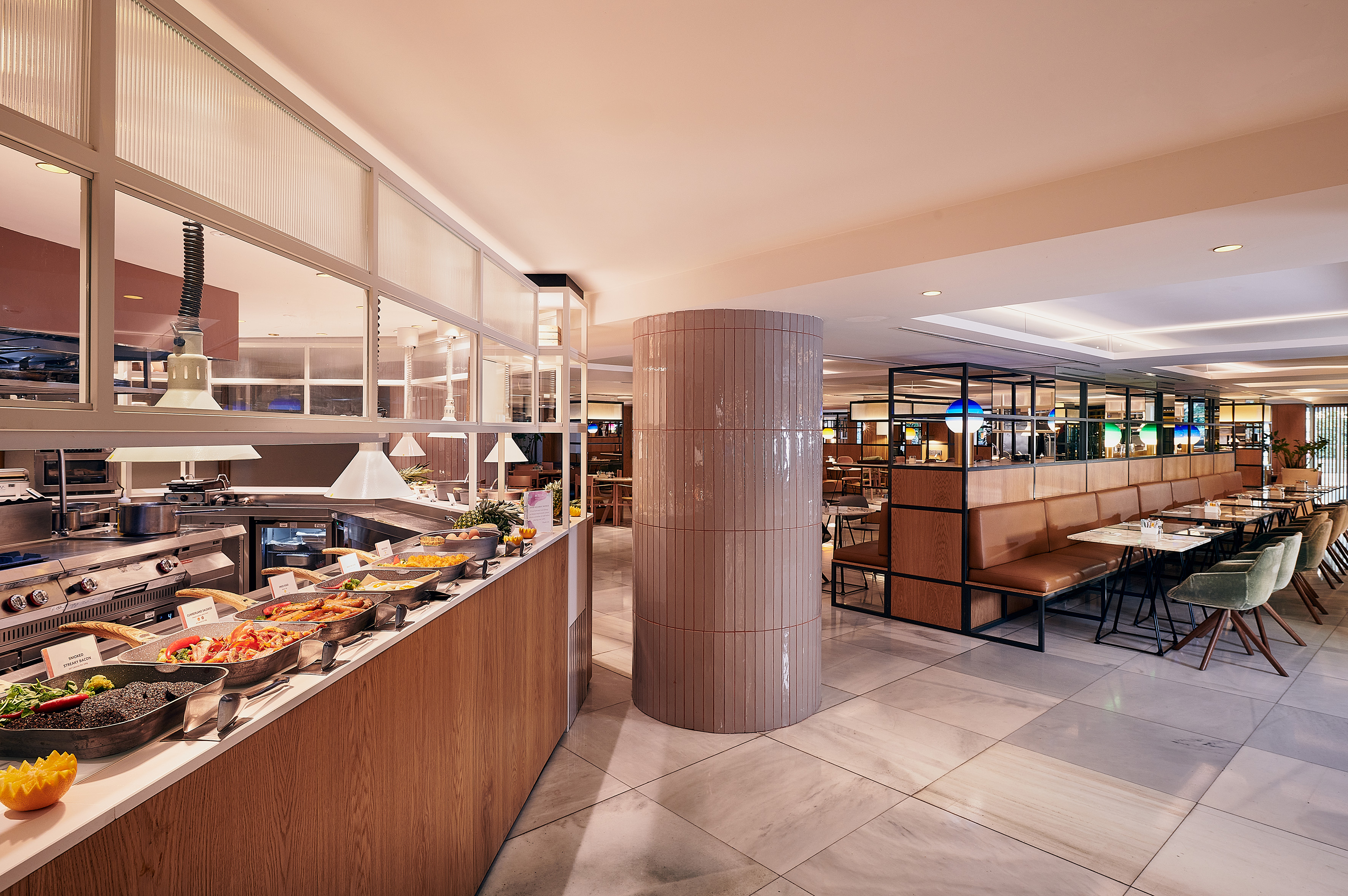 Hotel breakfast buffet with hot food counter and contemporary dining room.