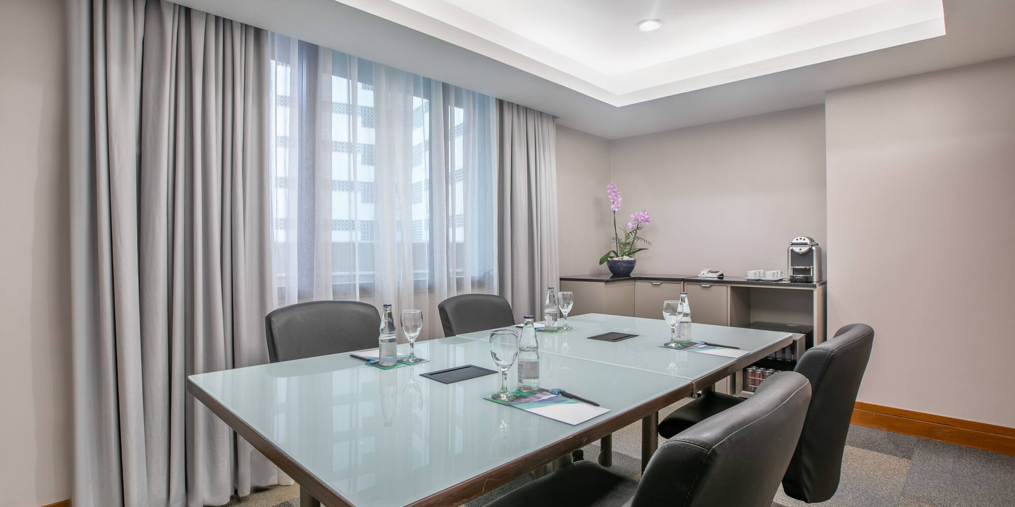 a conference room with a table and chairs