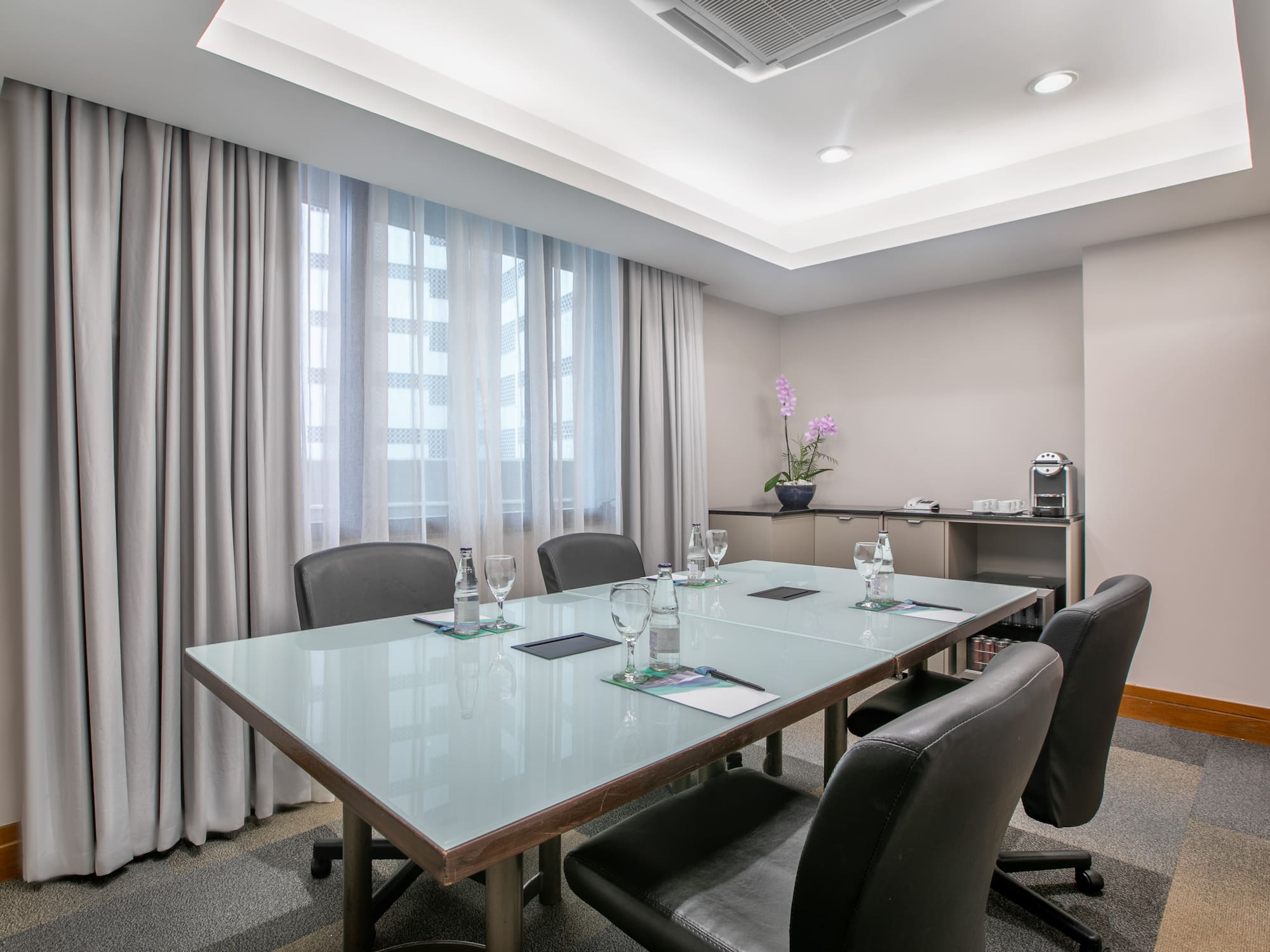 a conference room with a table and chairs