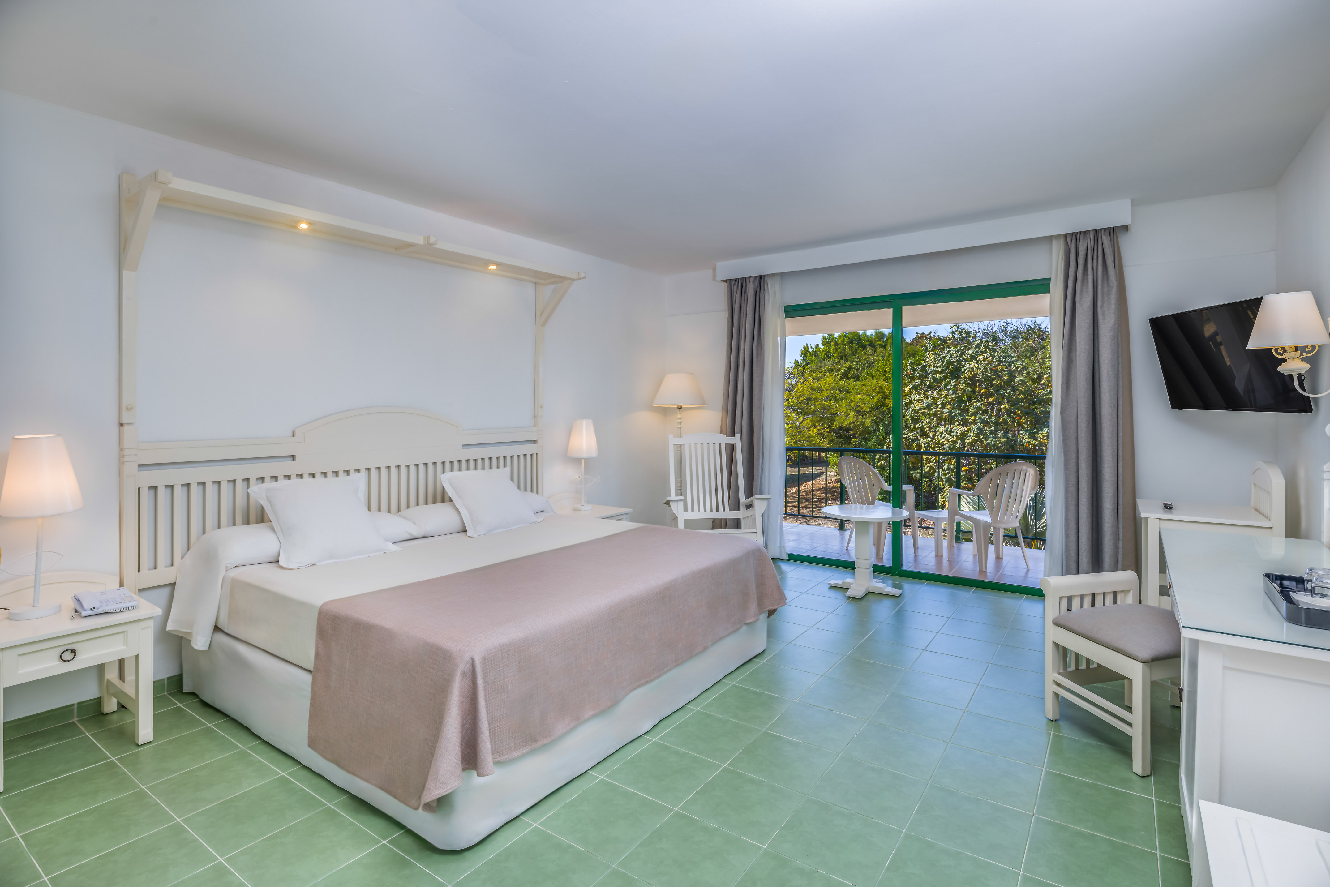 a bedroom with a bed and chairs.