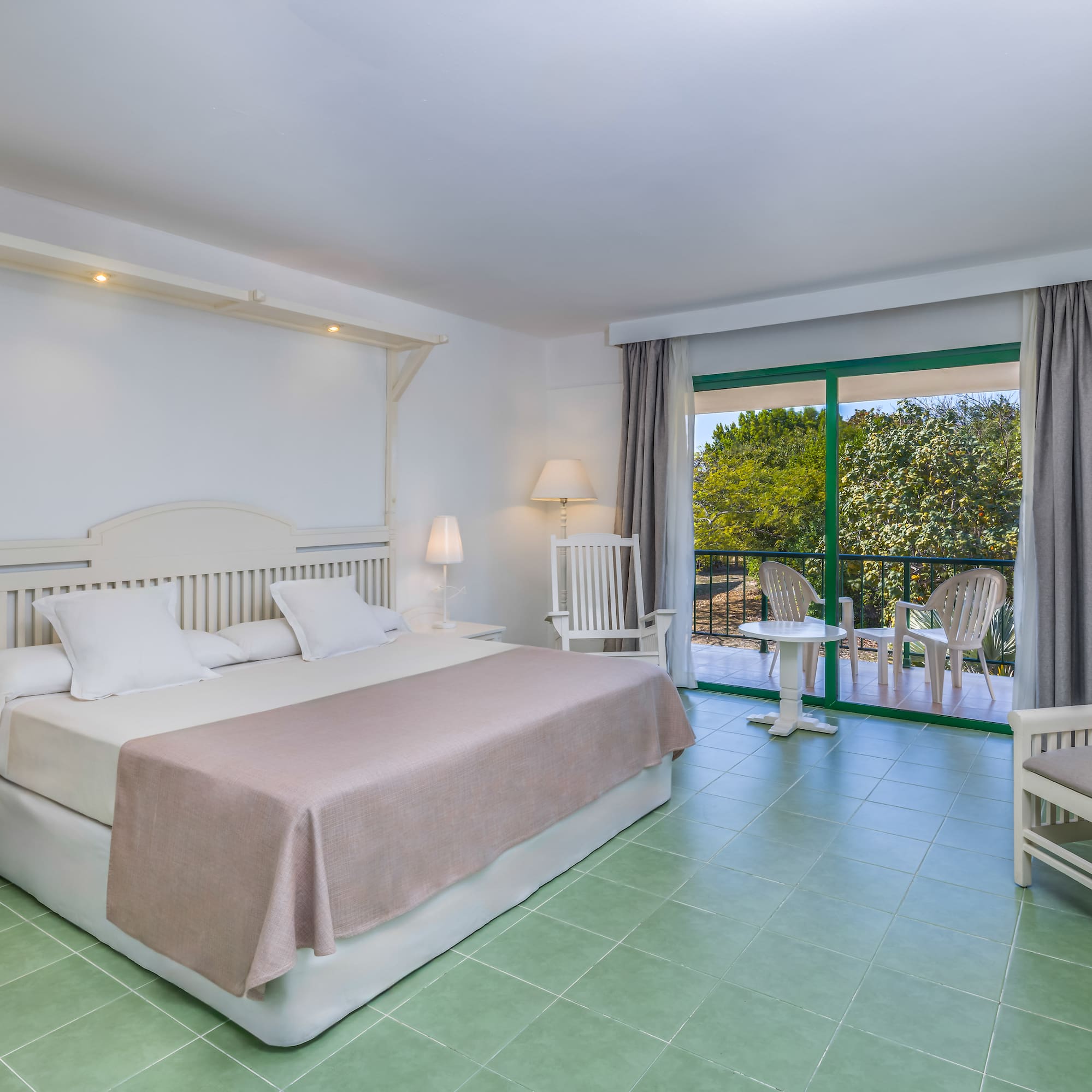 a bedroom with a bed and chairs.