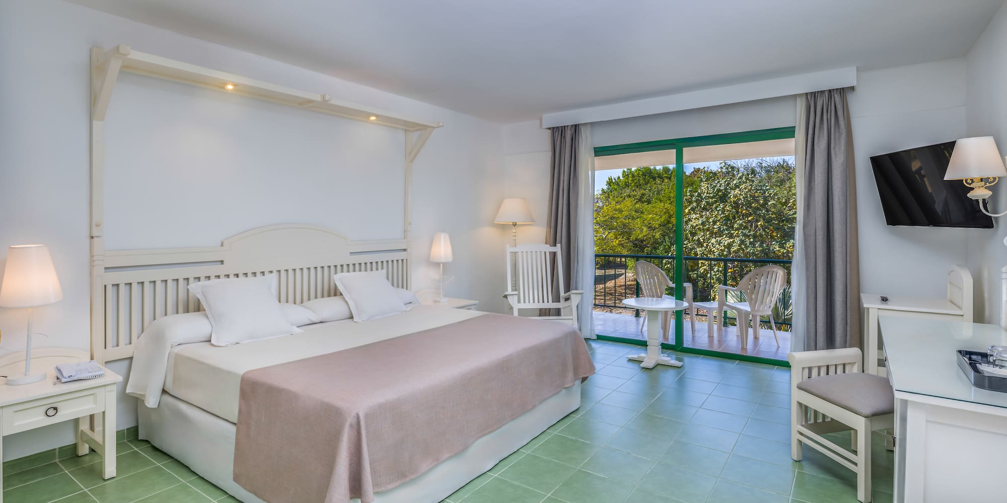 a bedroom with a bed and chairs.