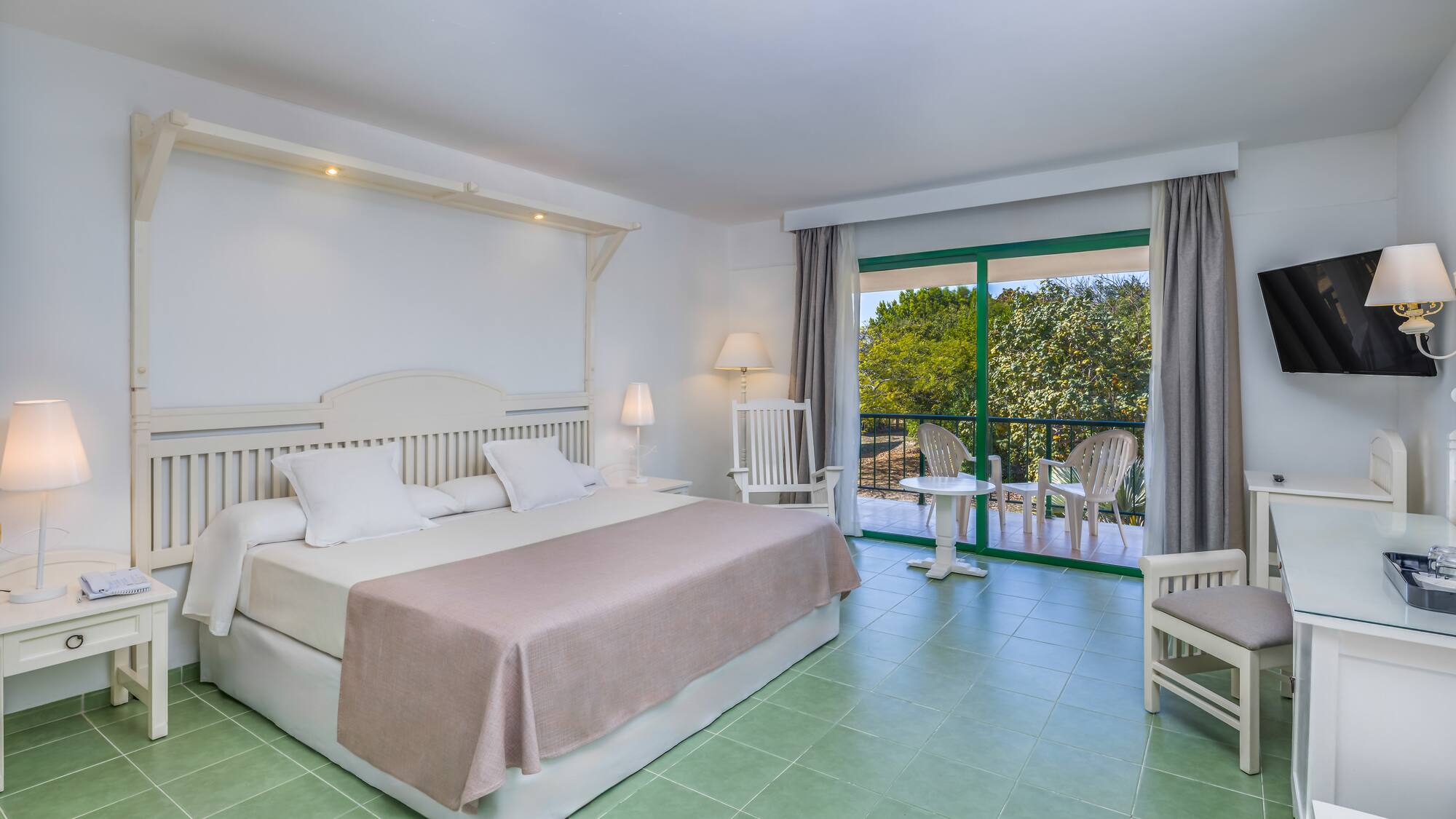 a bedroom with a bed and chairs.