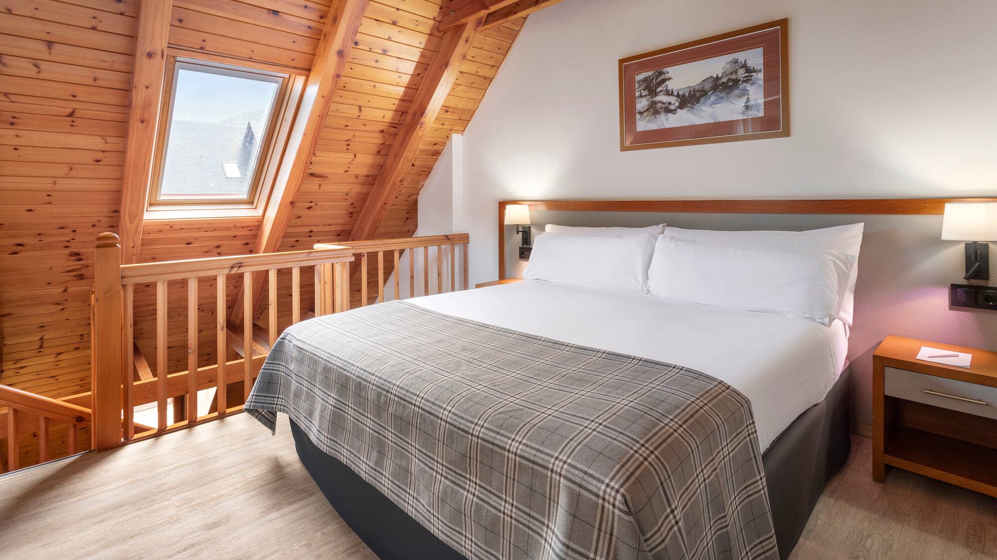 a bed in a room with a wood ceiling and a picture on the wall