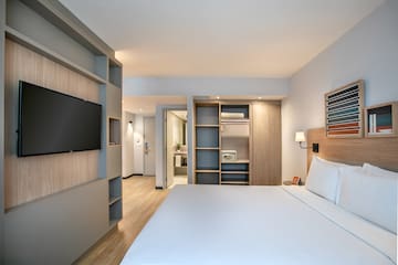 a room with a bed and a tv