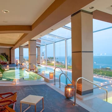 a indoor pool with a view of the ocean
