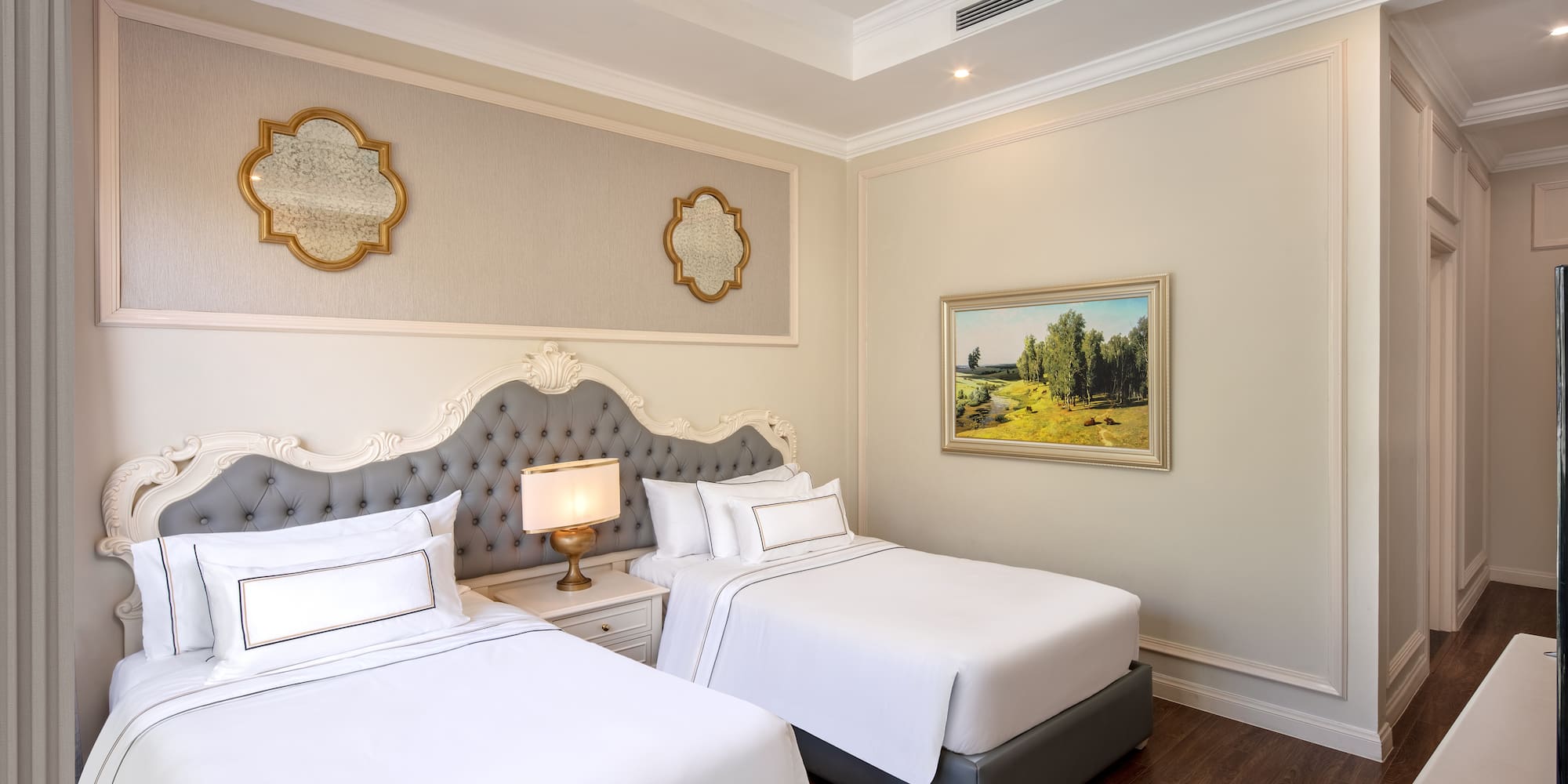 a room with two beds and a picture on the wall