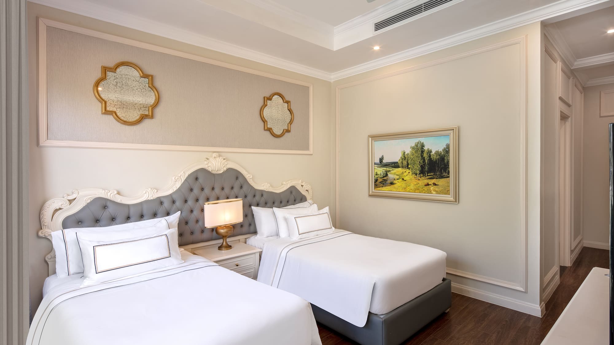 a room with two beds and a picture on the wall