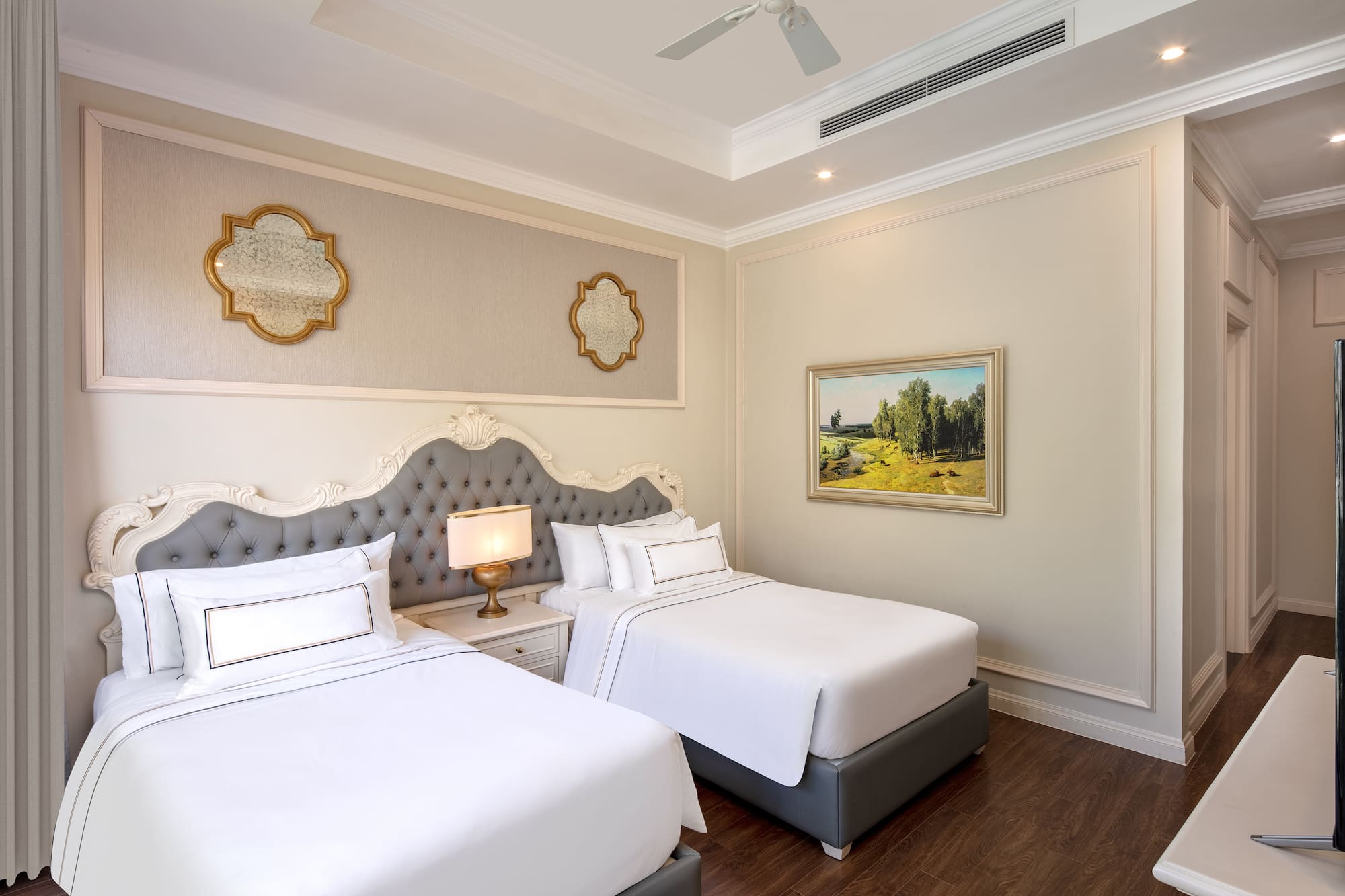 a room with two beds and a picture on the wall