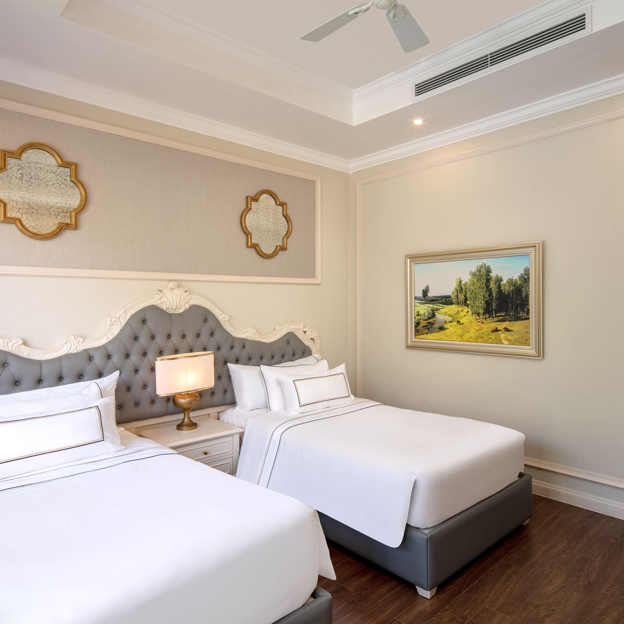 a room with two beds and a picture on the wall