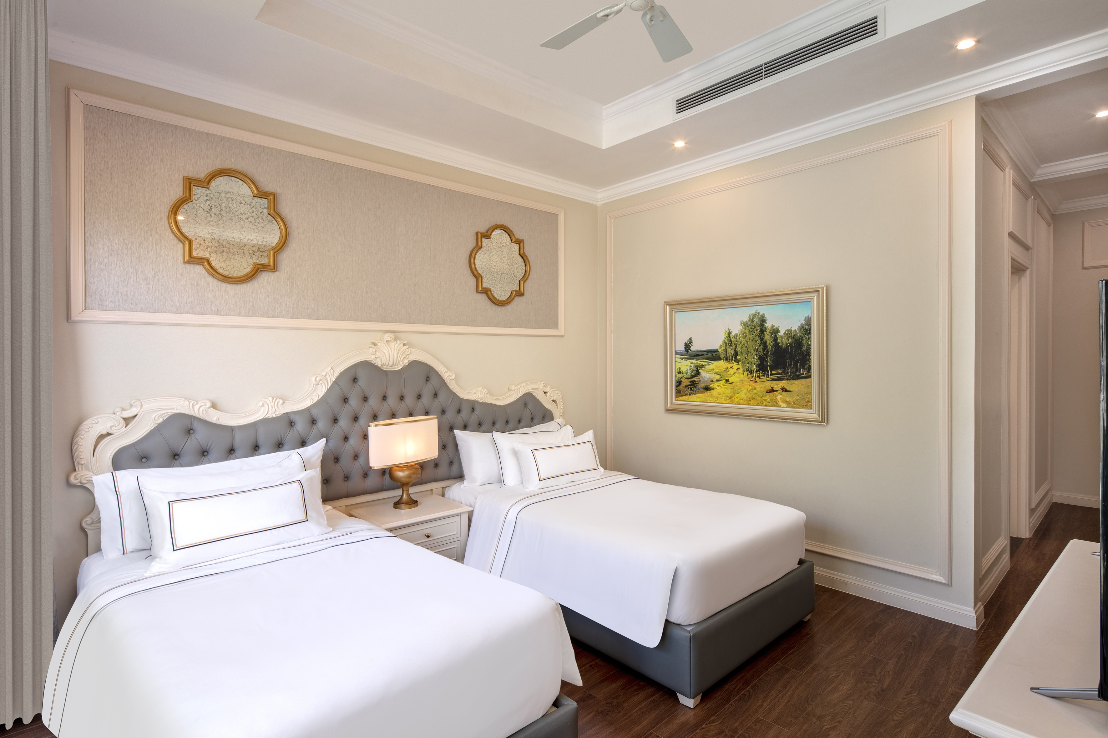 a room with two beds and a picture on the wall