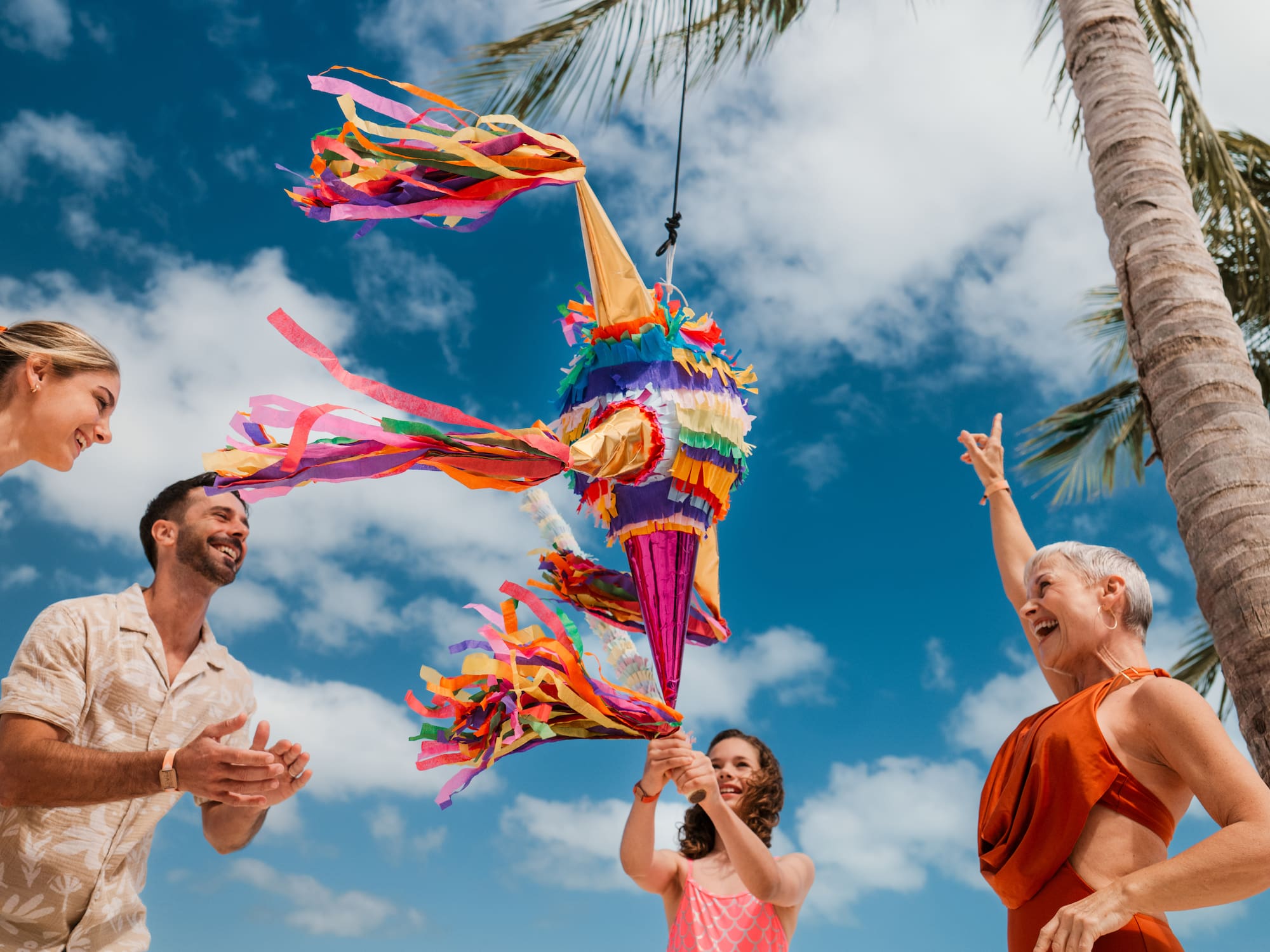 a group of people holding a pinata
