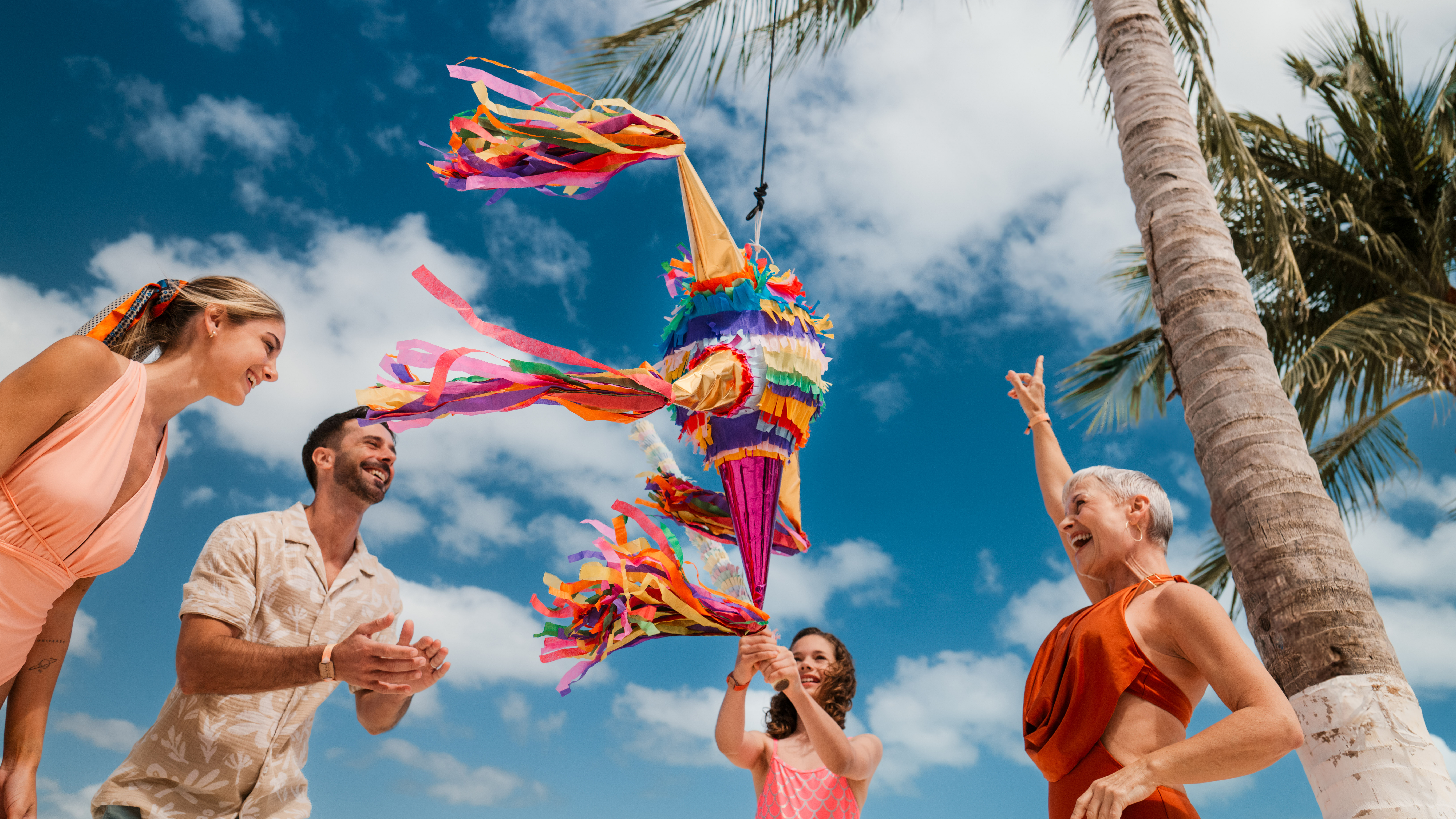 a group of people holding a pinata