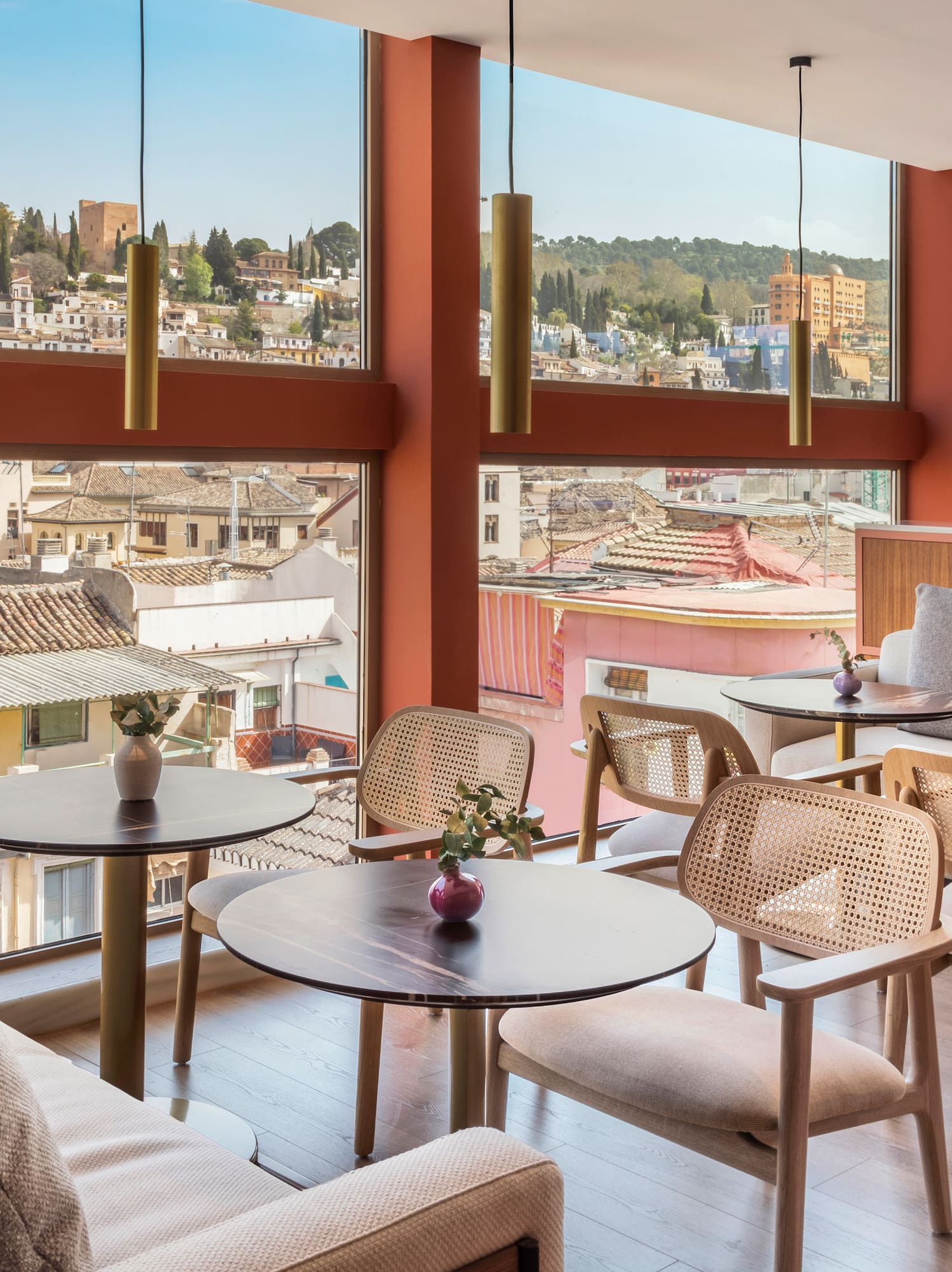 a room with tables and chairs and a view of a city