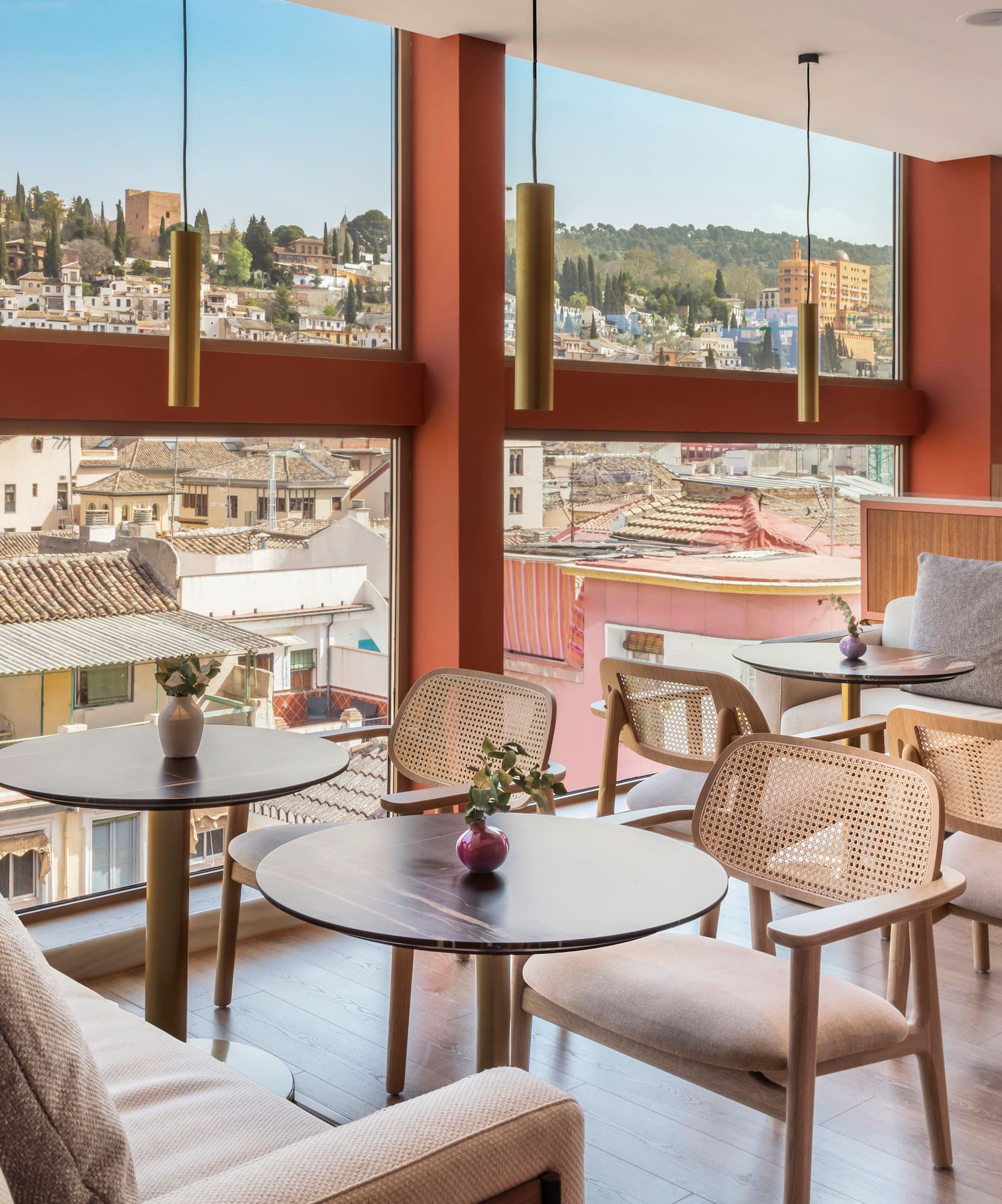 a room with tables and chairs and a view of a city