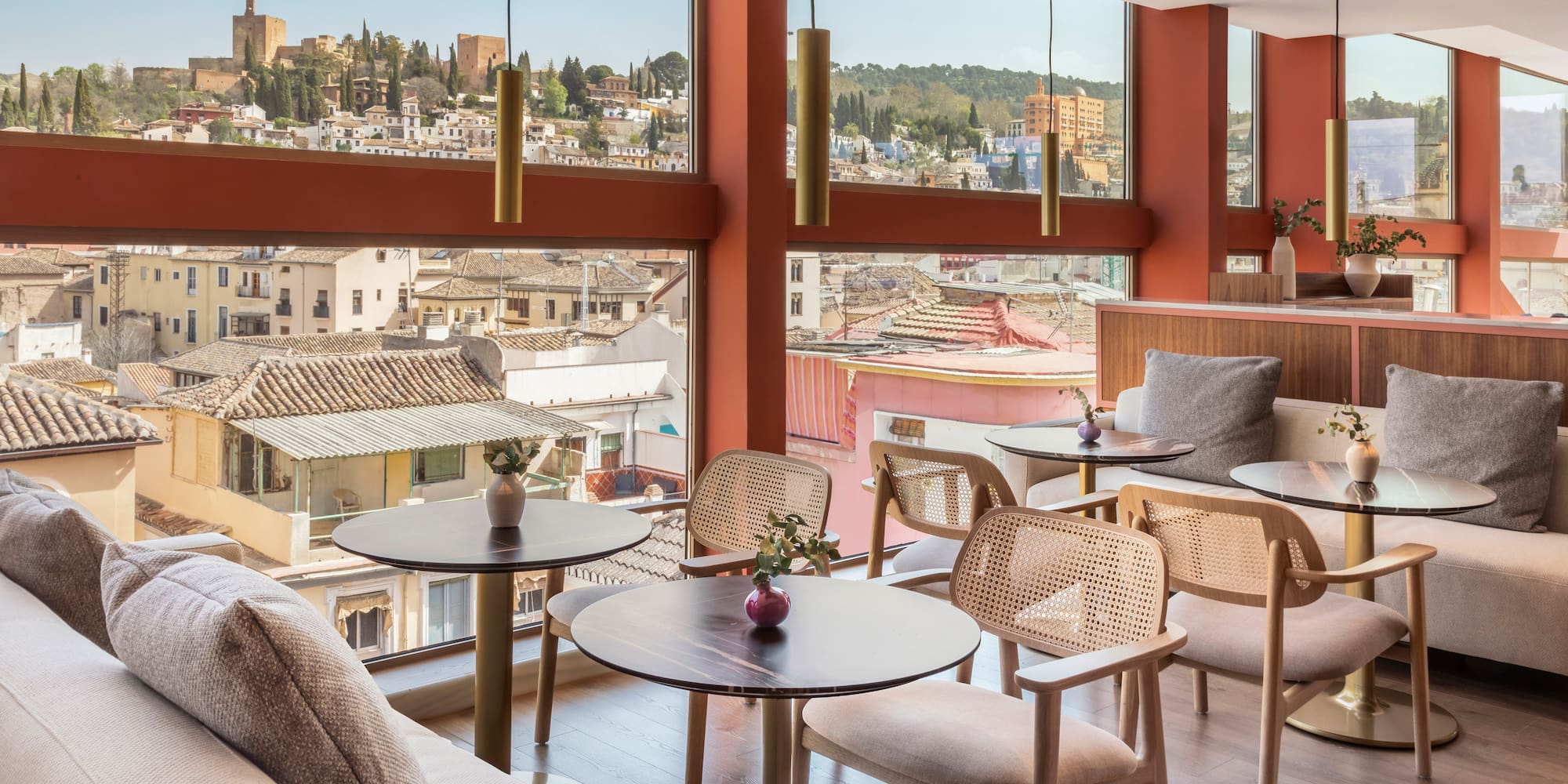 a room with tables and chairs and a view of a city