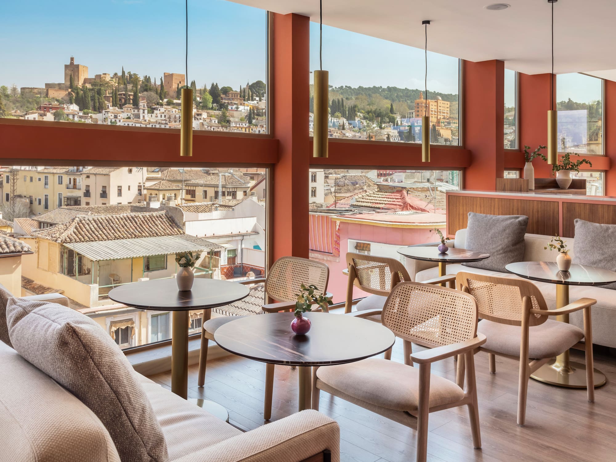 a room with tables and chairs and a view of a city
