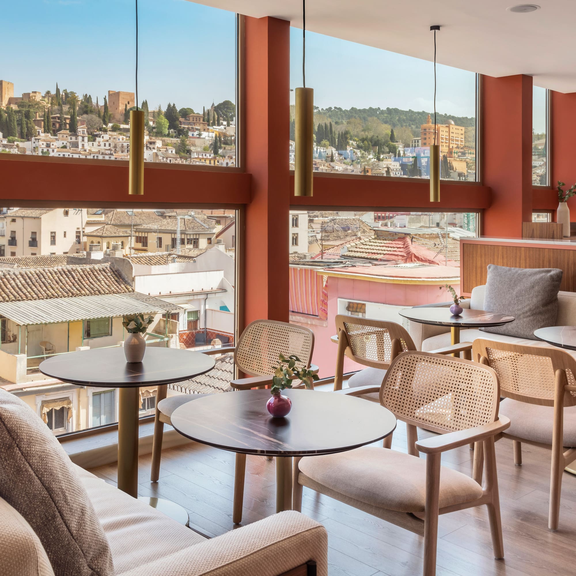a room with tables and chairs and a view of a city