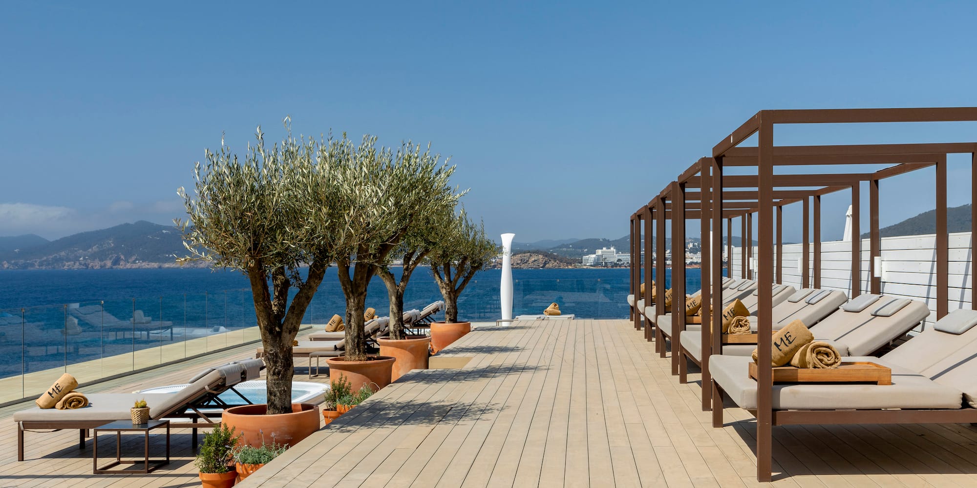 a deck with chairs and trees on the side