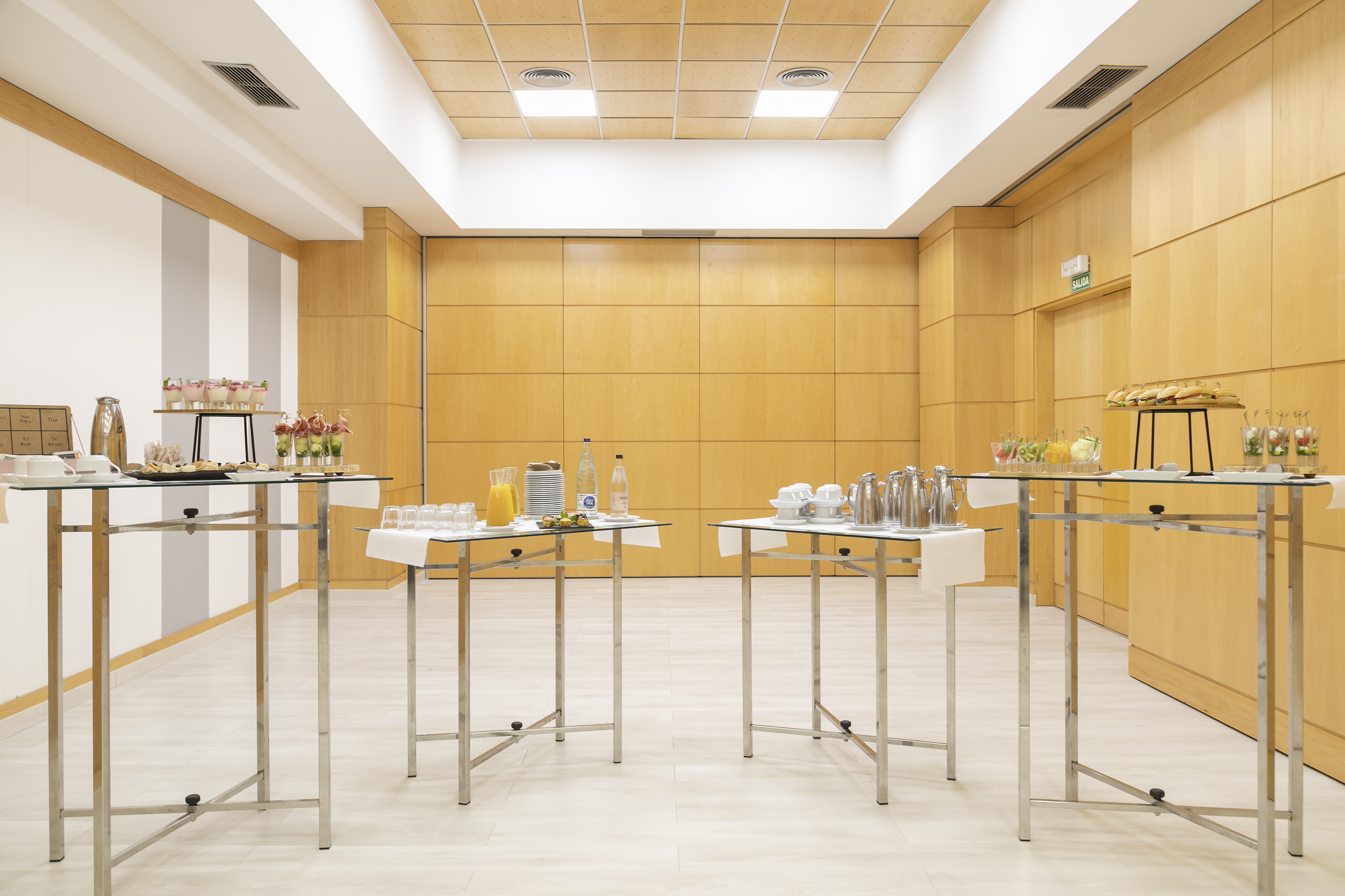 Conference break room with buffet catering, drinks, and snacks on tables.