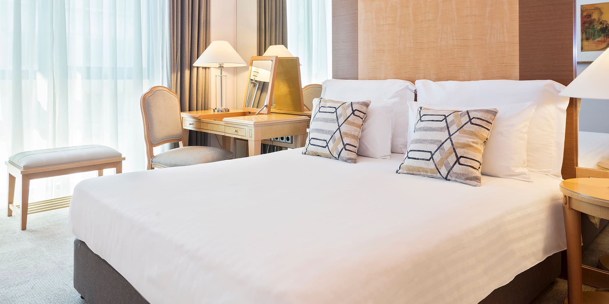 a bed with a desk and lamp