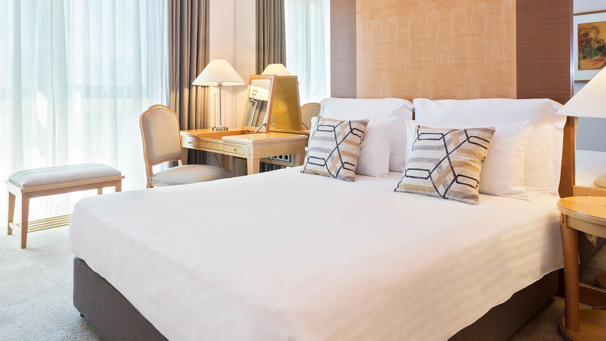 a bed with a desk and lamp