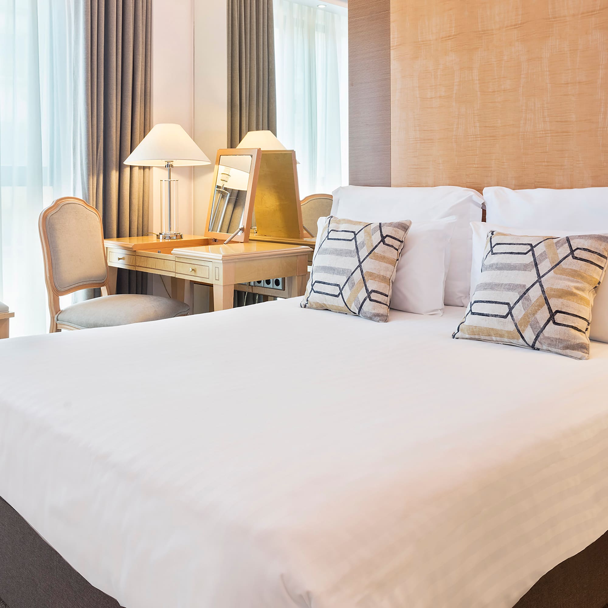 a bed with a desk and lamp