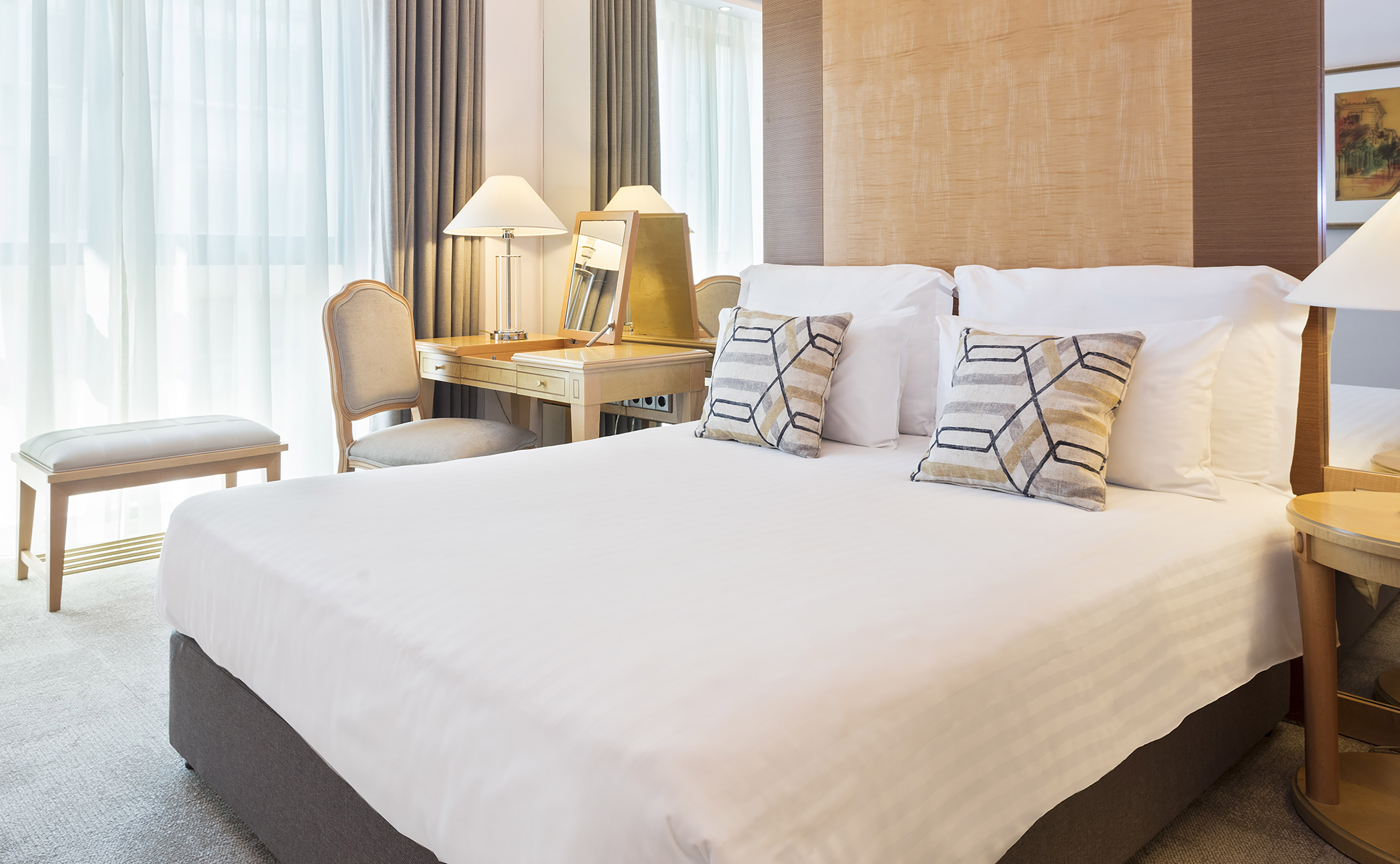 a bed with a desk and lamp