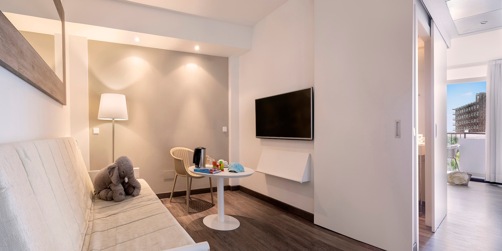 a room with a couch and a table and a tv