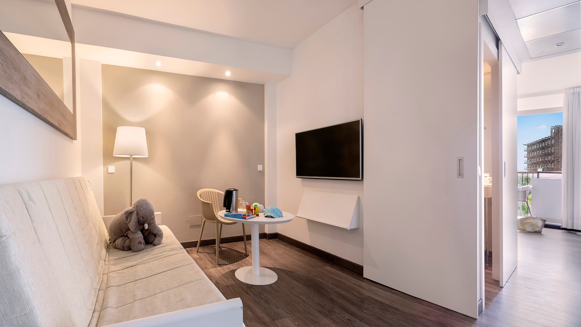 a room with a couch and a table and a tv