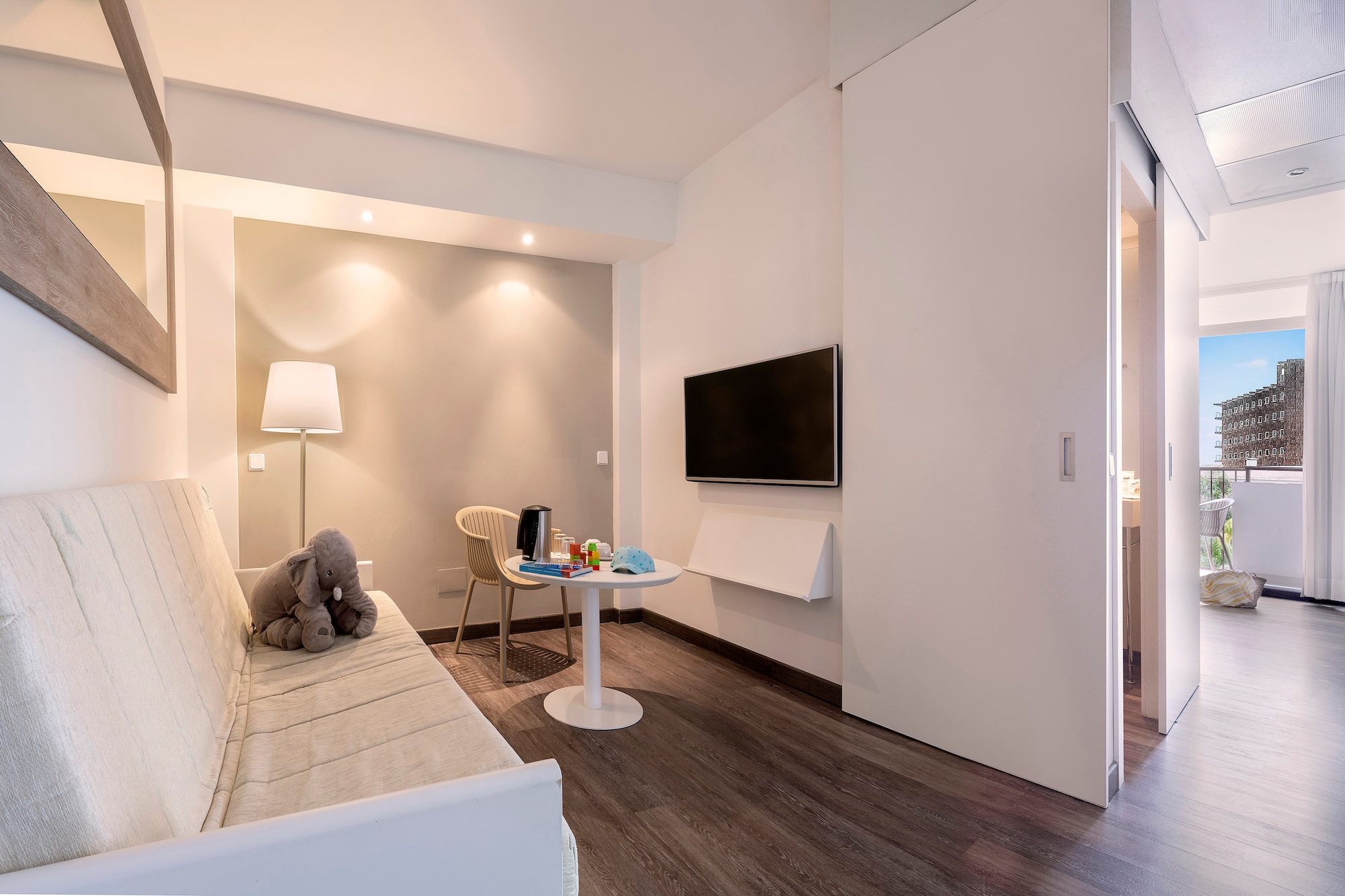 a room with a couch and a table and a tv