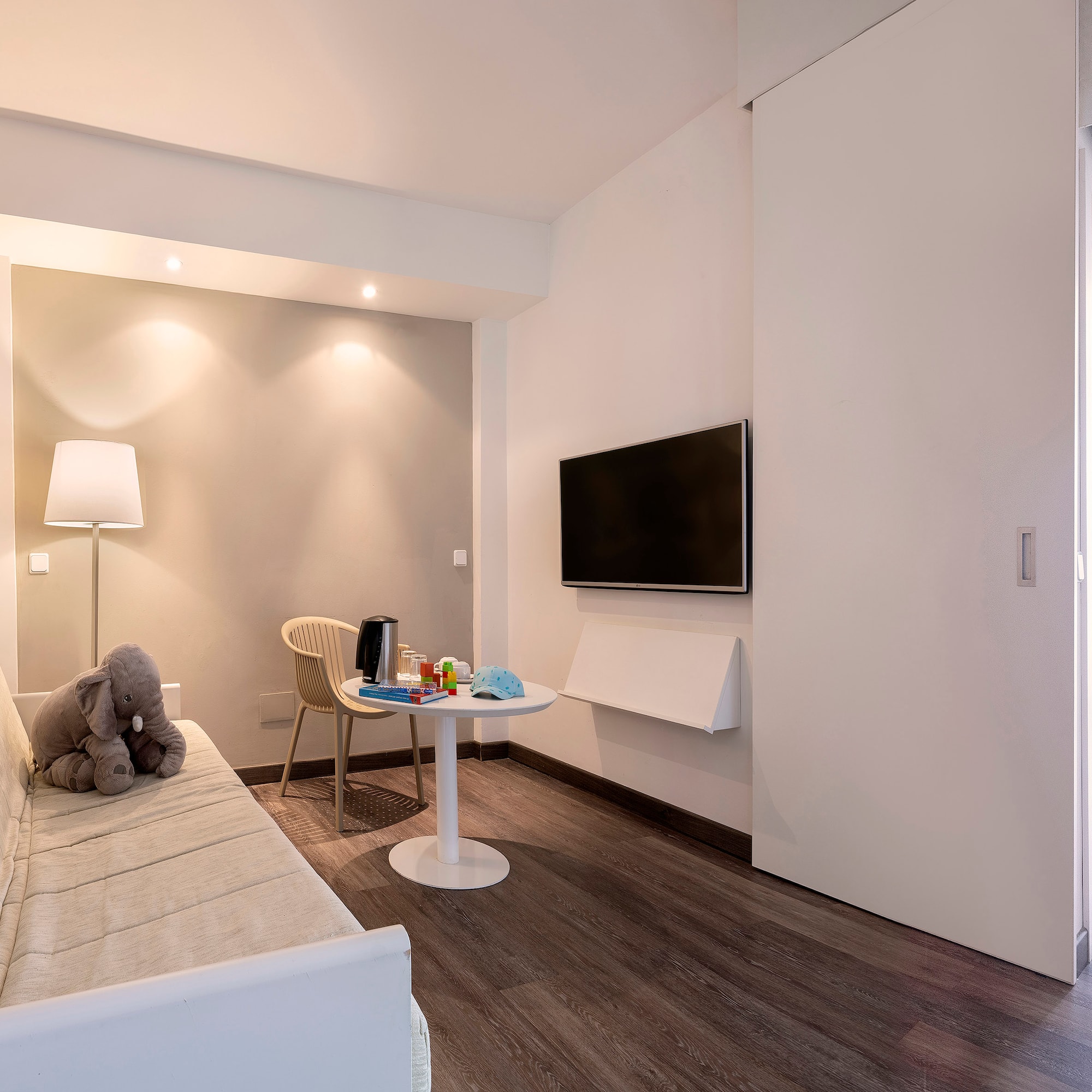 a room with a couch and a table and a tv