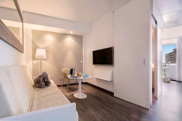 a room with a couch and a table and a tv