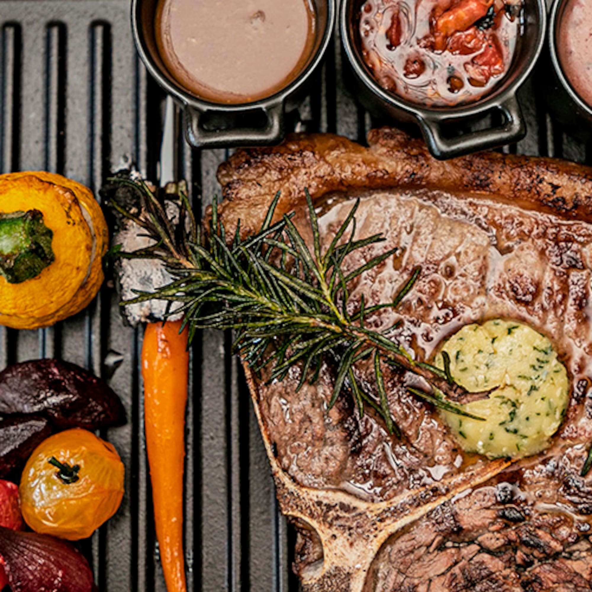 a steak and vegetables on a grill