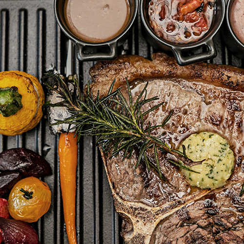 a steak and vegetables on a grill