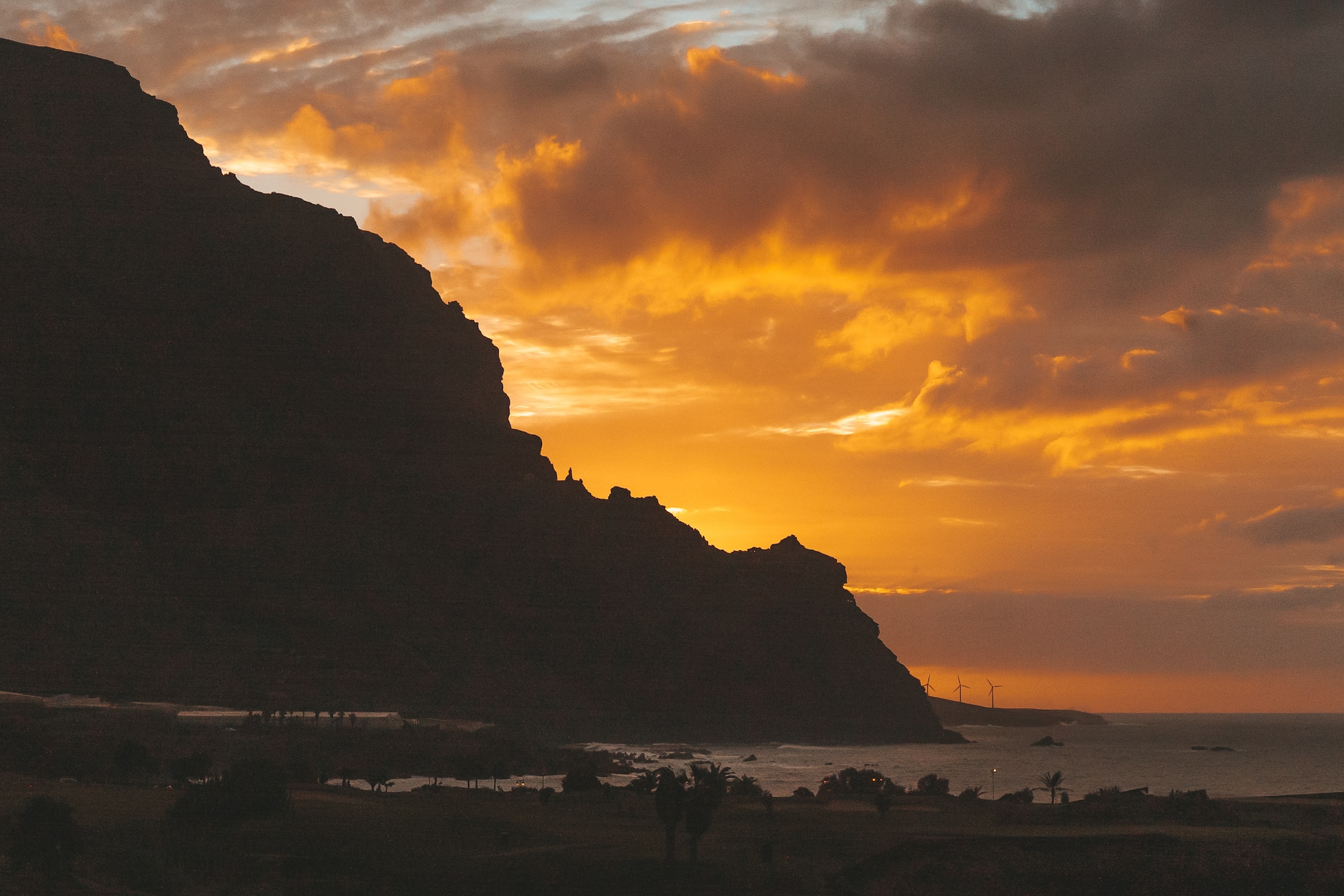 a sunset over a mountain